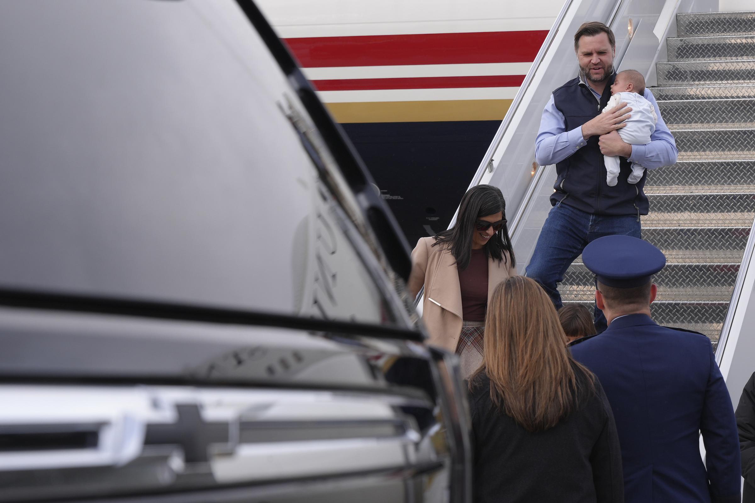 JD Vance holds nine-week-old Alec close as he descends the steps of Air Force Two following the family's arrival in Anchorage, Alaska. | Source: Getty Images