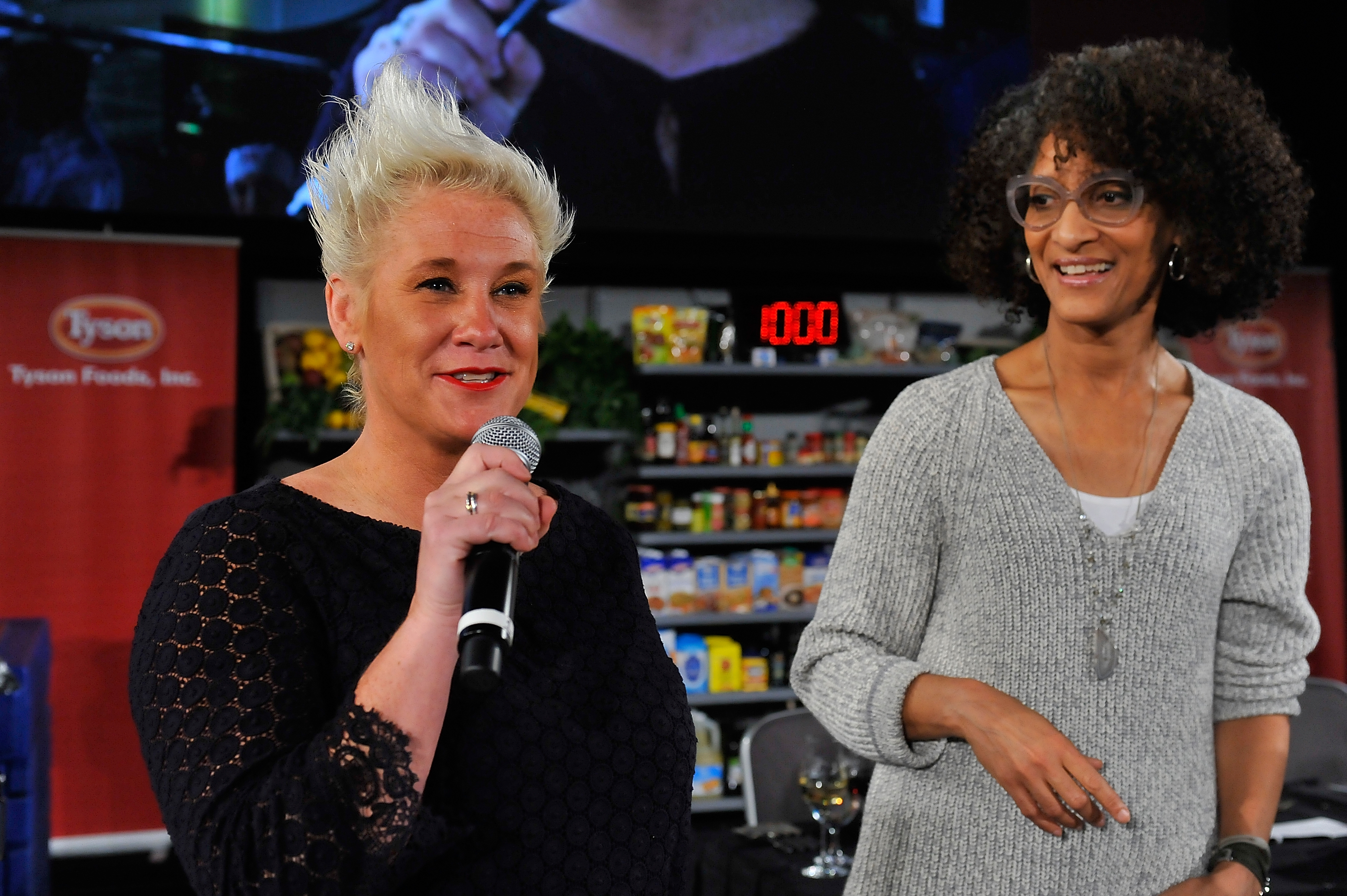 Anne Burrell and Carla Hall speak on stage at DC Central Kitchen's Capital Food Fight at the Ronald Reagan Building in Washington, DC, on November 12, 2015 | Source: Getty Images