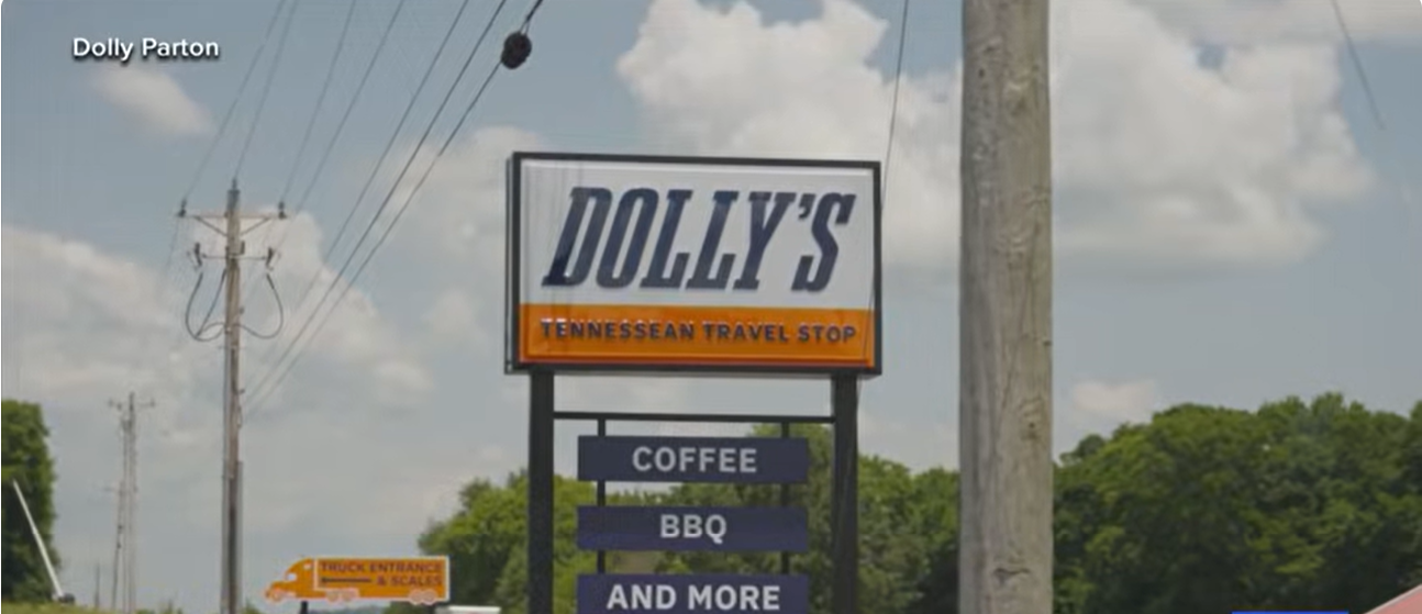 A roadside sign welcomes travelers to Dolly's Tennessean Travel Stop, highlighting some of the food and amenities awaiting visitors at the newly opened destination. | Source: TikTok/nc5nashville