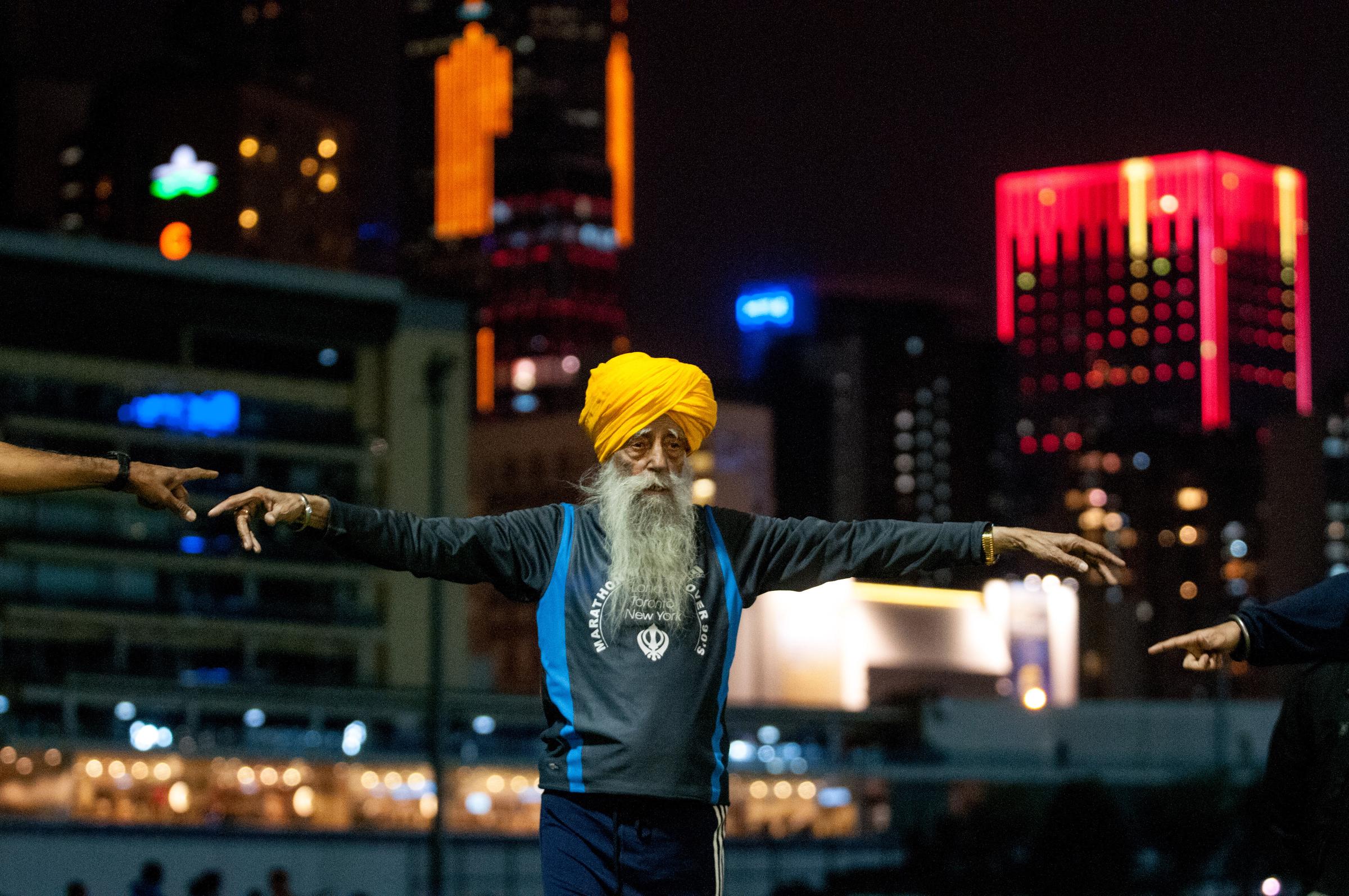 Fauja Singh warming up before the Hong Kong Marathon on February 22, 2013. | Source: Getty Images