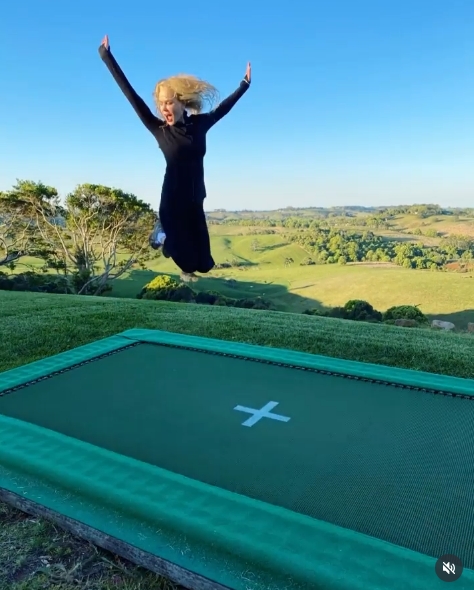 A trampoline is set into the manicured hillside lawn, overlooking sweeping views of the lush Australian countryside — a playful touch against the serene natural backdrop. From a post dated October 10, 2020. | Source: Instagram/nicolekidman
