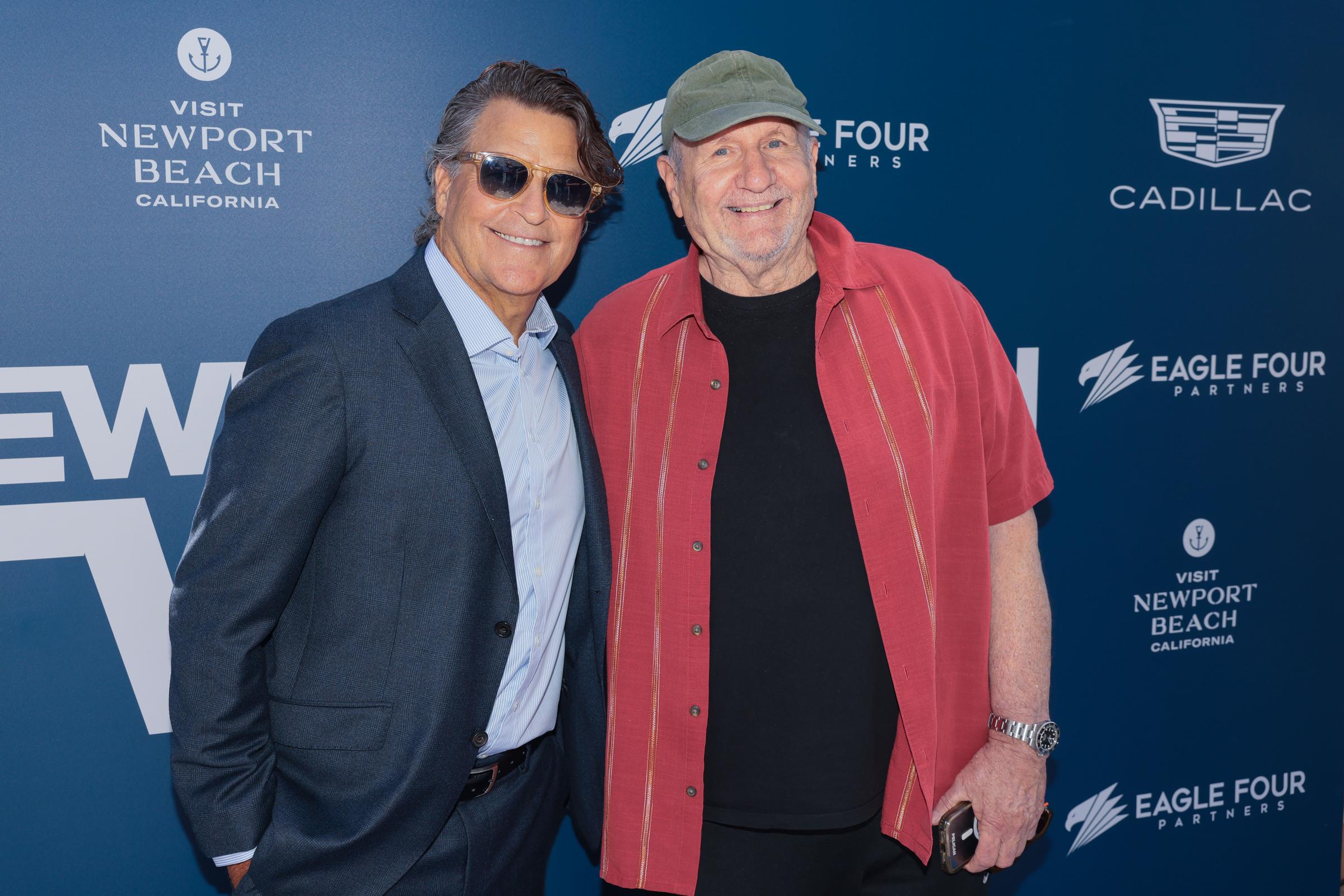 Ted McGinley and Ed O'Neill reunited with broad smiles while attending the "Shrinking" Ensemble Panel during the Newport Beach TV FEST at the Lido Theater on June 7, 2026, in Newport Beach, California. The former "Married... with Children" co-stars looked stylish side by side, with McGinley donning a sharp dark suit jacket, light dress shirt, and tortoise-framed sunglasses, while O'Neill kept it relaxed in a short-sleeve red camp collar shirt over a black tee, paired with an olive green flat cap. | Source: Getty Images