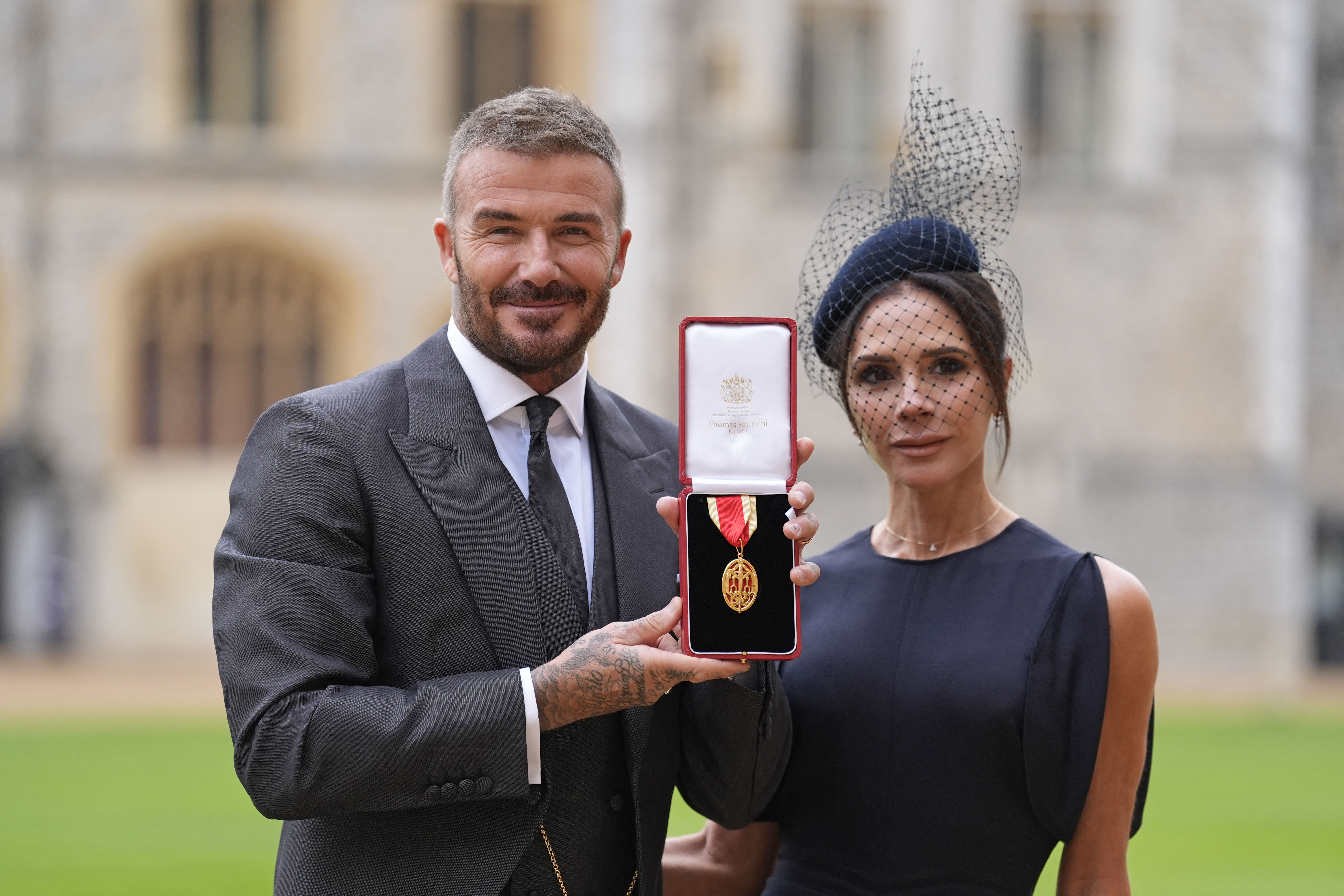 David Beckham poses with his wife, Victoria Beckham, and his medal after receiving a knighthood at Windsor Castle in England on November 4, 2025. | Source: Getty Images
