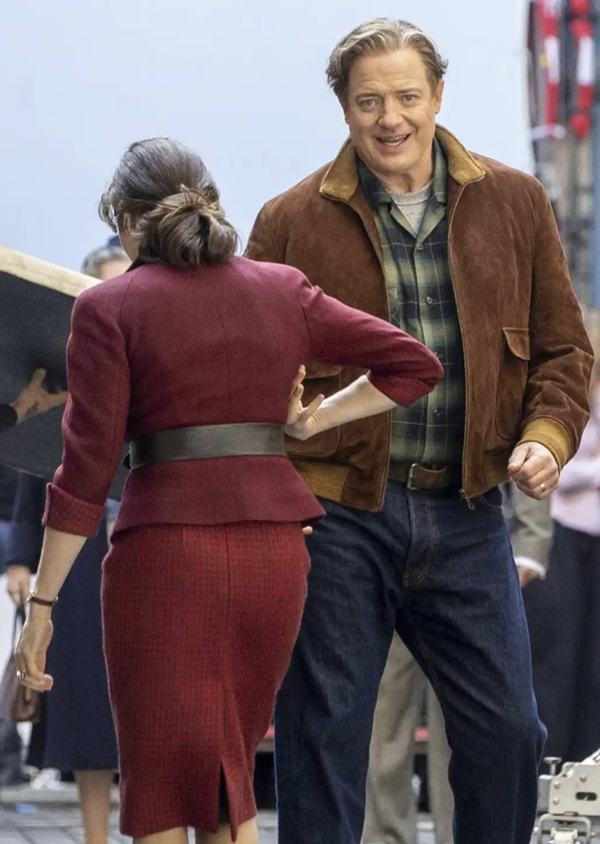 Brendan Fraser appears in a brown jacket and plaid shirt in new behind-the-scenes photos, showing off his noticeably slimmer figure as he reunites with Rachel Weisz. | Source: Instagram/@people.