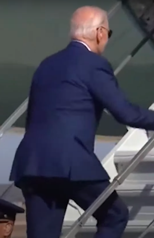 Joe Biden tripping slightly up the steps to Air Force One. | Source: YouTube/New York Post