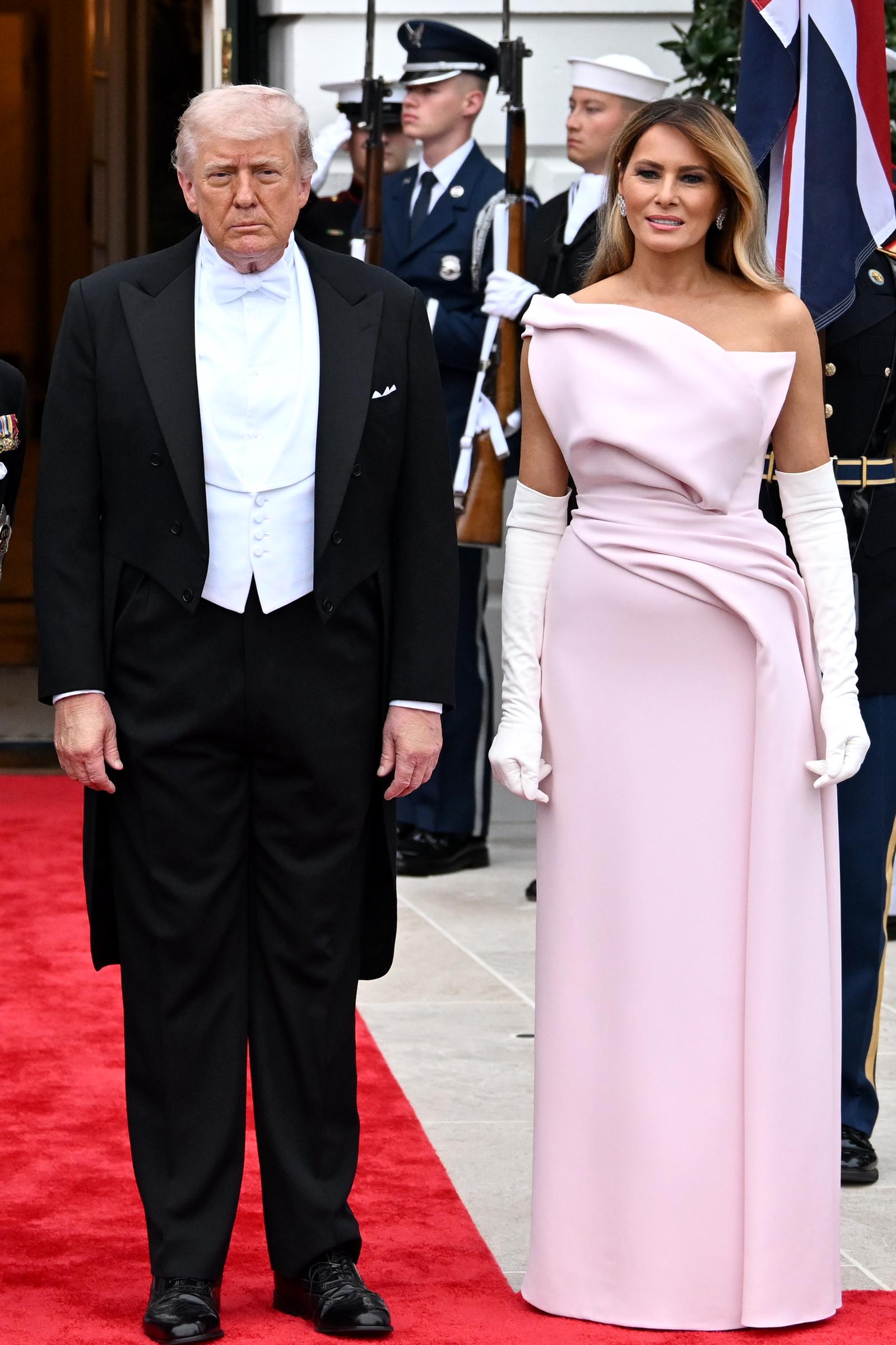 Donald and Melania Trump stand together as they welcome guests to the White House state dinner on April 28, 2026 | Source: Getty Images