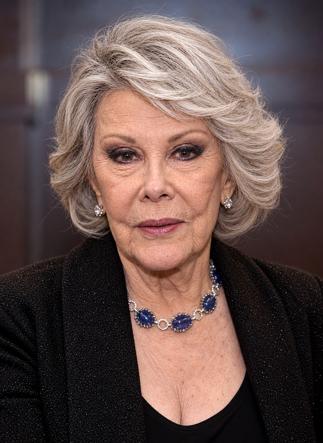 AI imagines Joan with prominent lines across her forehead, cheeks, and around her eyes and mouth, framed by softly styled gray-blonde hair. | Source: ChatGPT