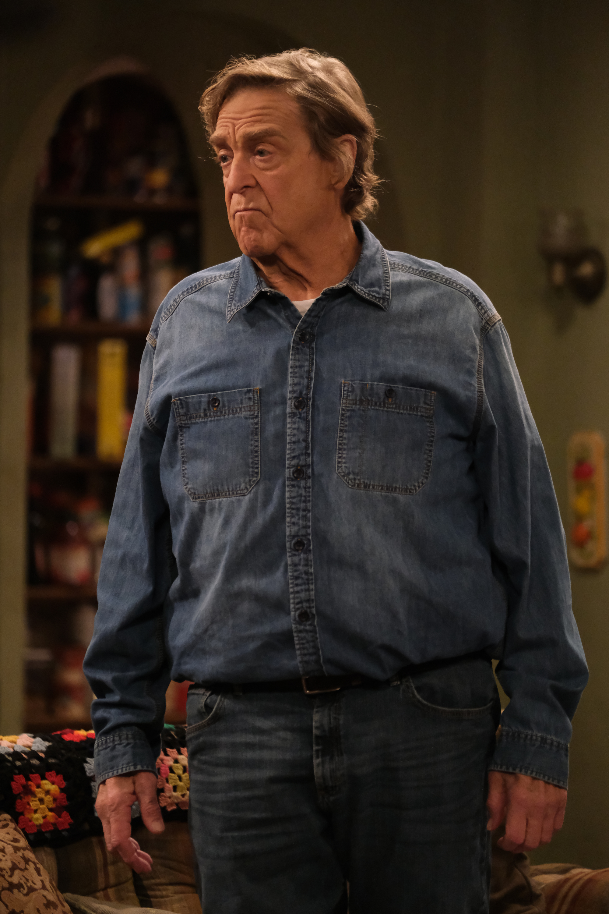A slimmed-down John Goodman is pictured on the set of "The Conners" in December 2020, continuing his longtime role as family patriarch Dan Conner. | Source: Getty Images