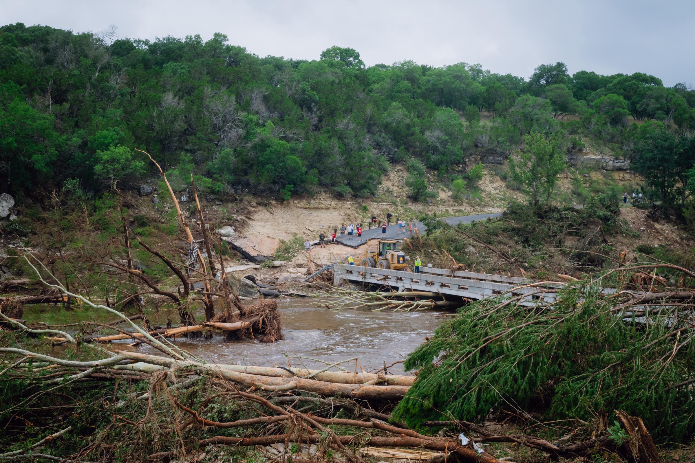 Construction crews clear debris on a bridge over the Guadalupe River in Kerr County, Texas on July 5, 2025. | Source: Getty Images