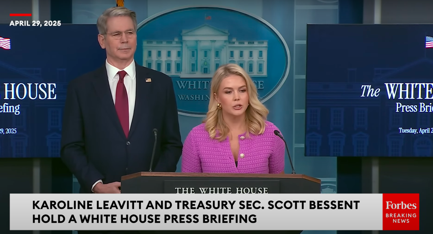 U.S. Treasury Secretary Scott Bessent standing beside Karoline Leavitt as she talks about Amazon's alleged plan. | Source: YouTube/Forbes Breaking News