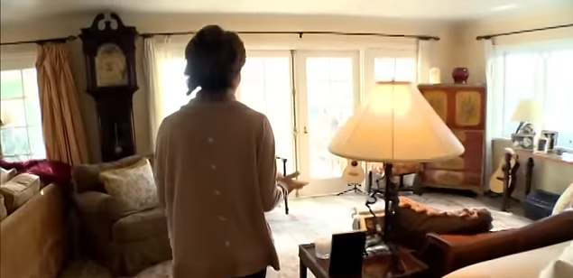 A vintage grandfather clock and a painted wooden armoire frame the bright, window-lined walls. | Source: YouTube/@Biography