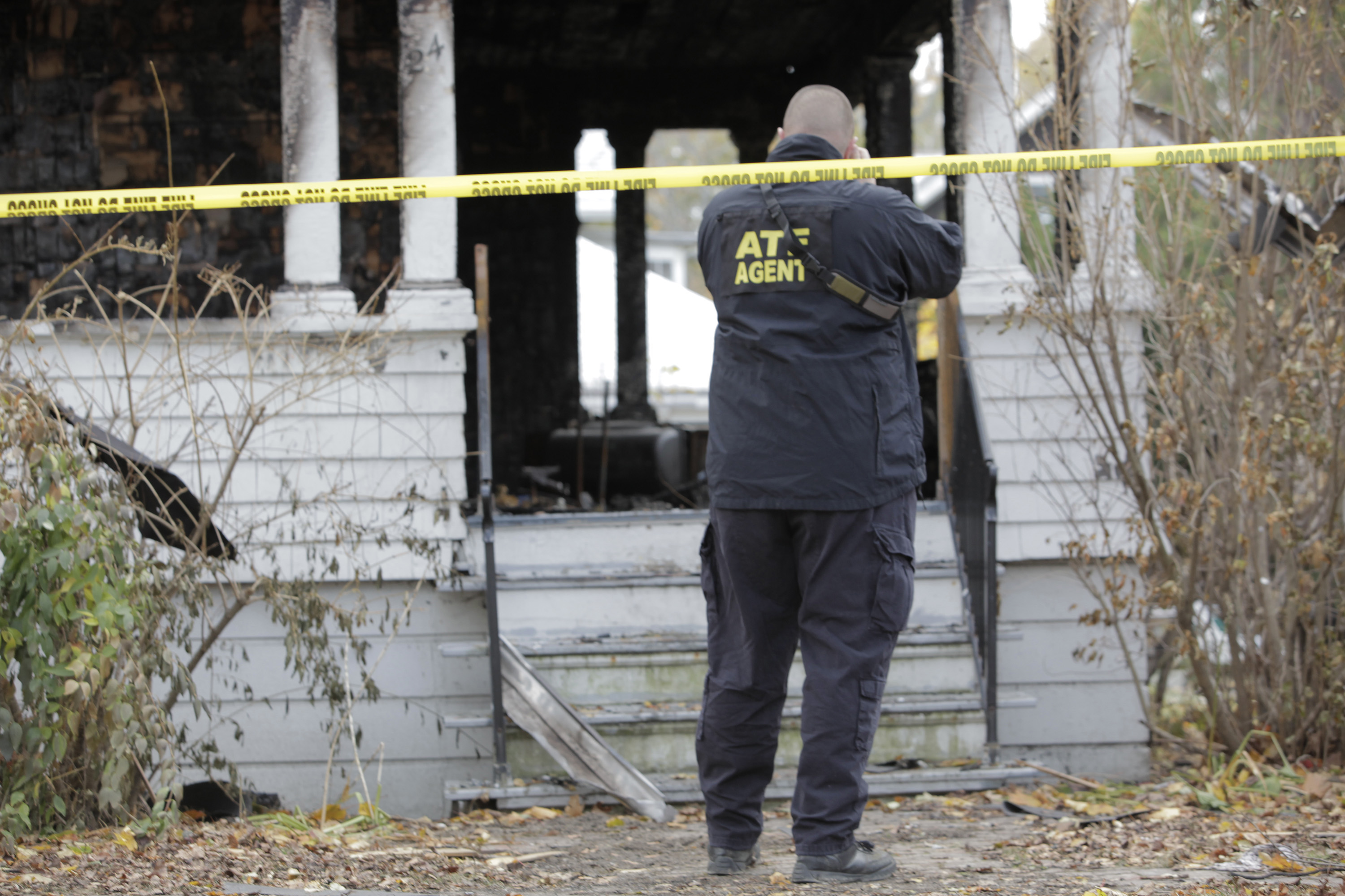 An ATF agent taking photographs of a house in Portland on November 3, 2014. | Source: Getty Images