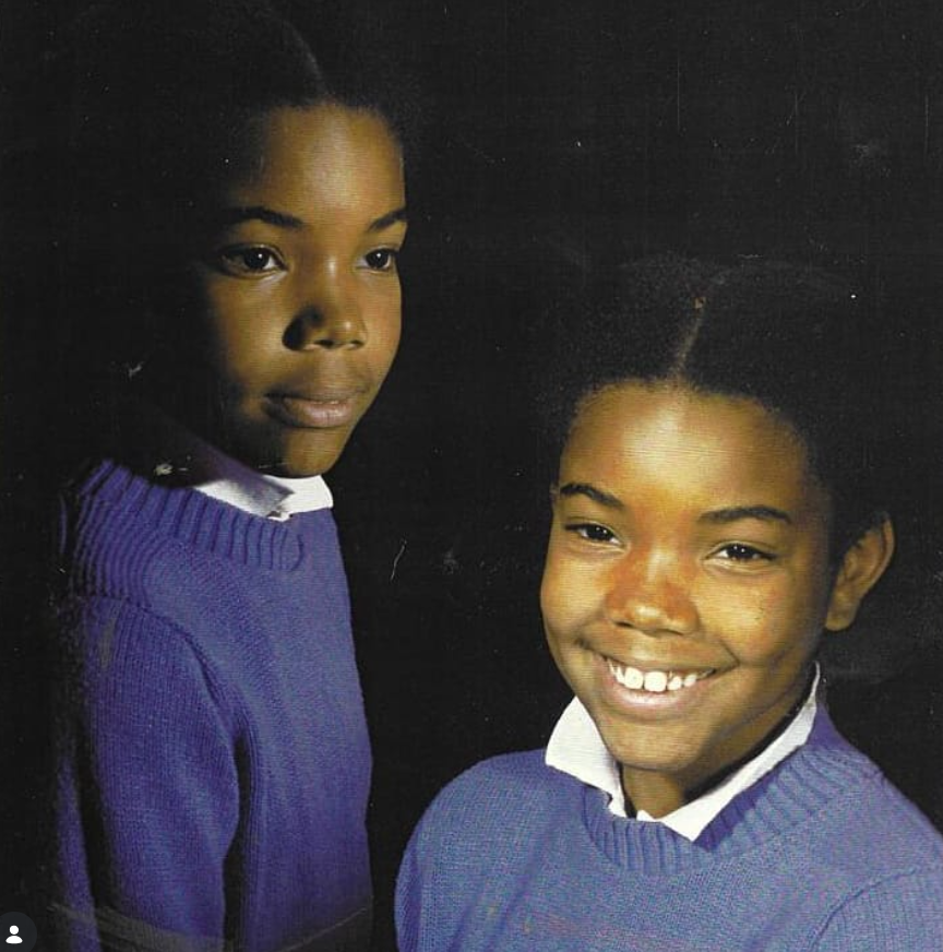 A young Gabrielle Union is pictured in a studio-style portrait, wearing a purple sweater layered over a white collared shirt. | Source: Instagram/gabunion