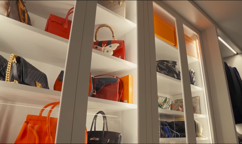 The handbag cabinets add boutique energy to the room. This is the kind of storage most people only see in luxury retail. | Source: YouTube/Architectural Digest