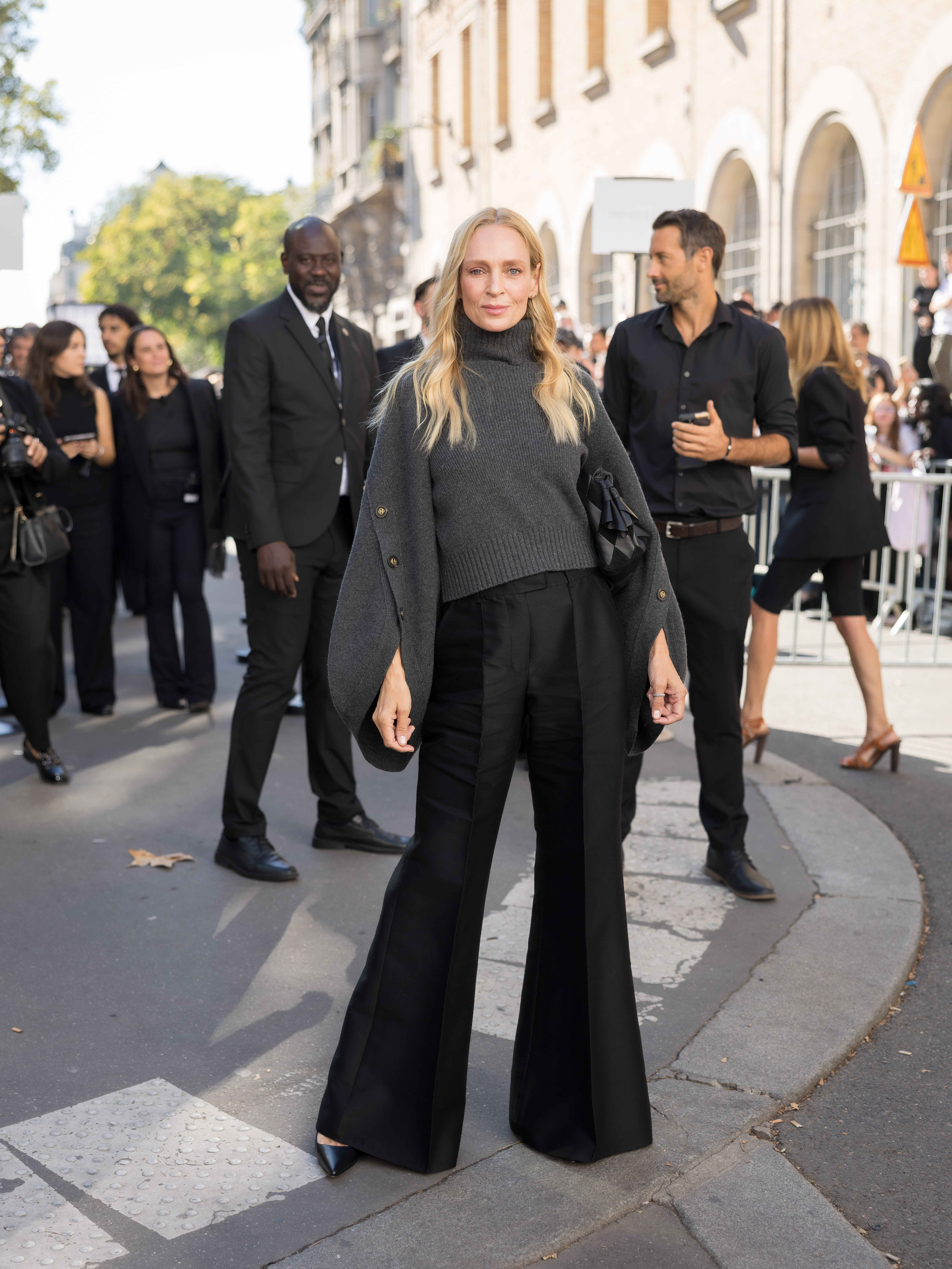 Wide flared trousers give Uma Thurman's all-black outfit its strongest visual feature. She paired them with a loose charcoal knit while stepping out in Paris for Zimmermann.