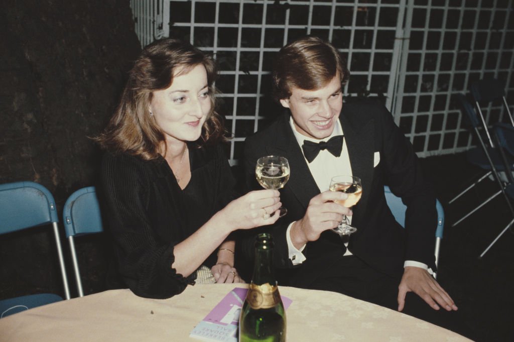 Amanda Knatchbull (L) lifting her drink for a toast, July 1980 | Source: Getty Images