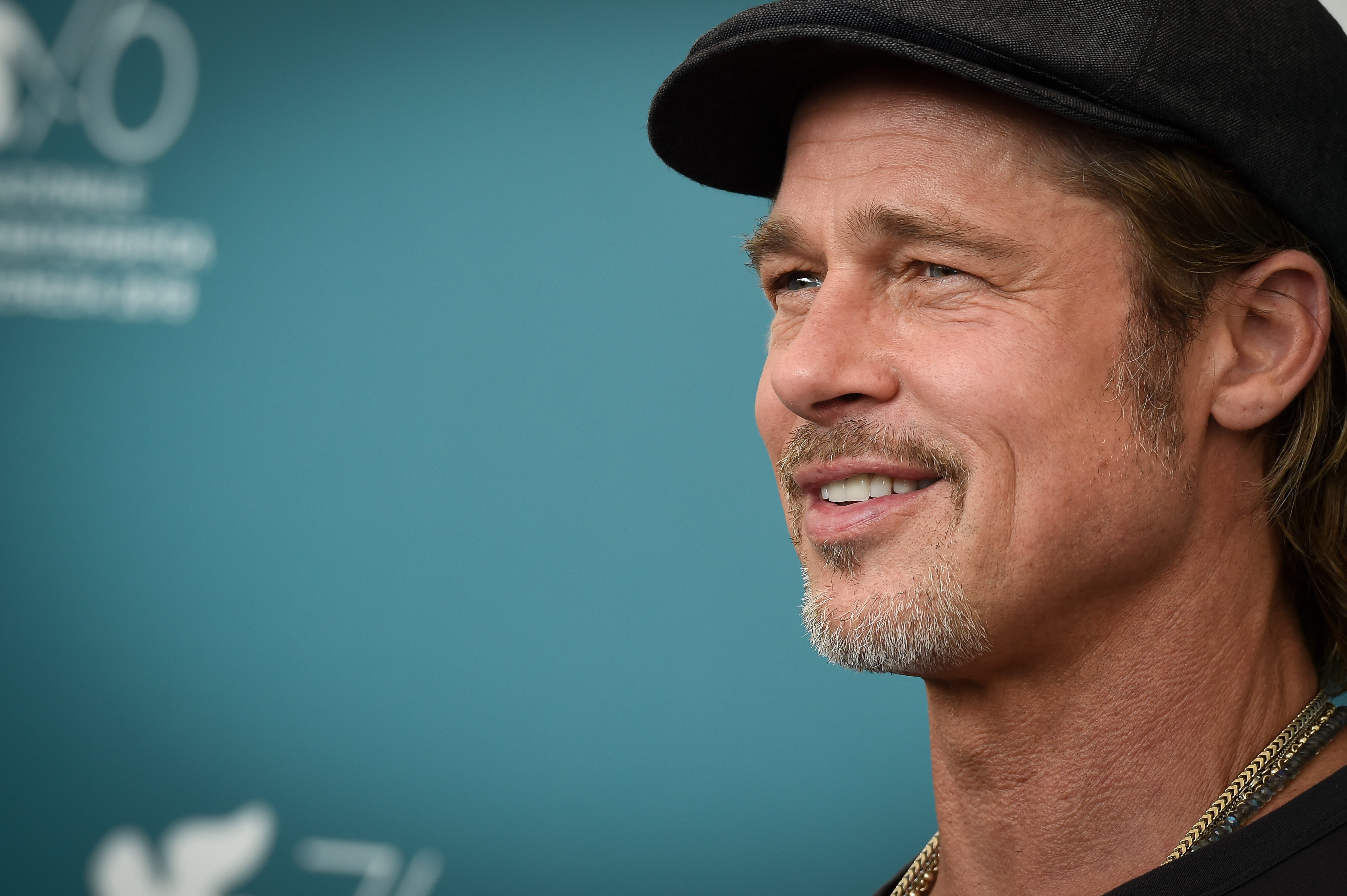 Years before his slicked-back look in San Sebastian, Pitt wore his hair longer beneath a dark cap while promoting "Ad Astra" at the Venice International Film Festival in 2019. The close-up shows an earlier hairstyle as his latest red-carpet look draws fresh attention. | Source: Getty Images