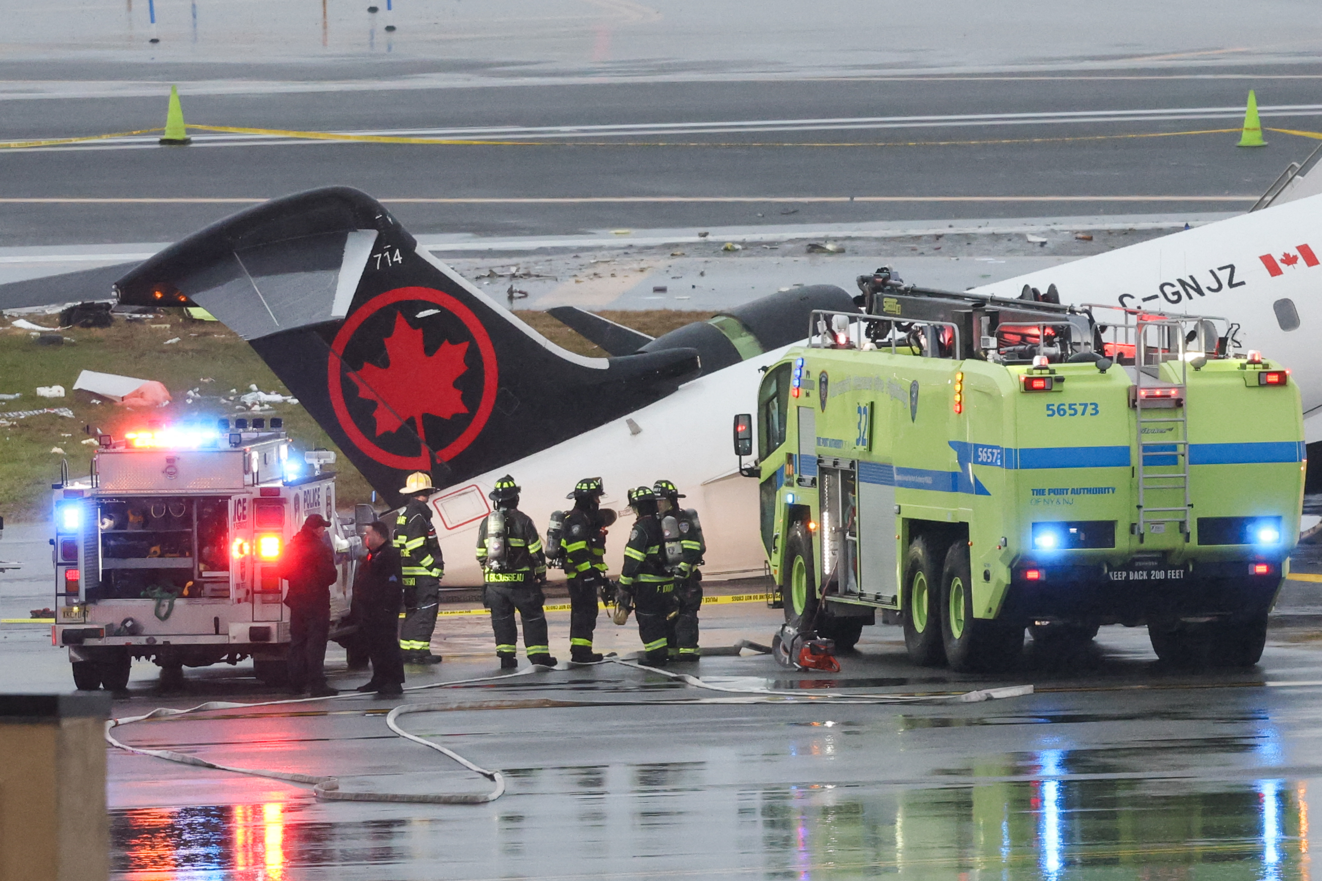 Emergency responders work as an Air Canada Express CRJ-900 sits on the runway after colliding with a Port Authority fire truck at LaGuardia Airport on March 23, 2026, in New York City | Getty Images