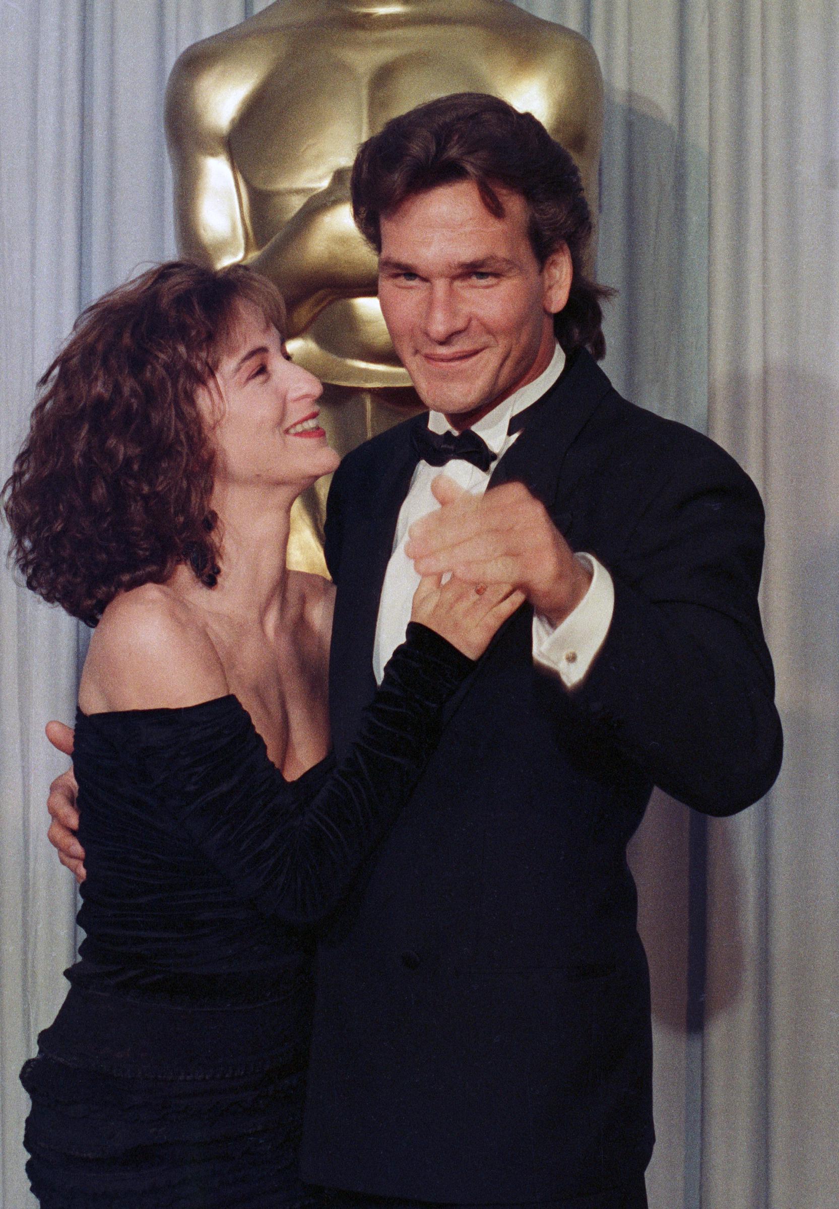 Jennifer Grey and Patrick Swayze share a lighthearted moment backstage at the Academy Awards in Los Angeles on April 11, 1988. Just months after "Dirty Dancing" became a worldwide sensation, the co-stars reunited at Hollywood's biggest night before Grey's appearance changed.