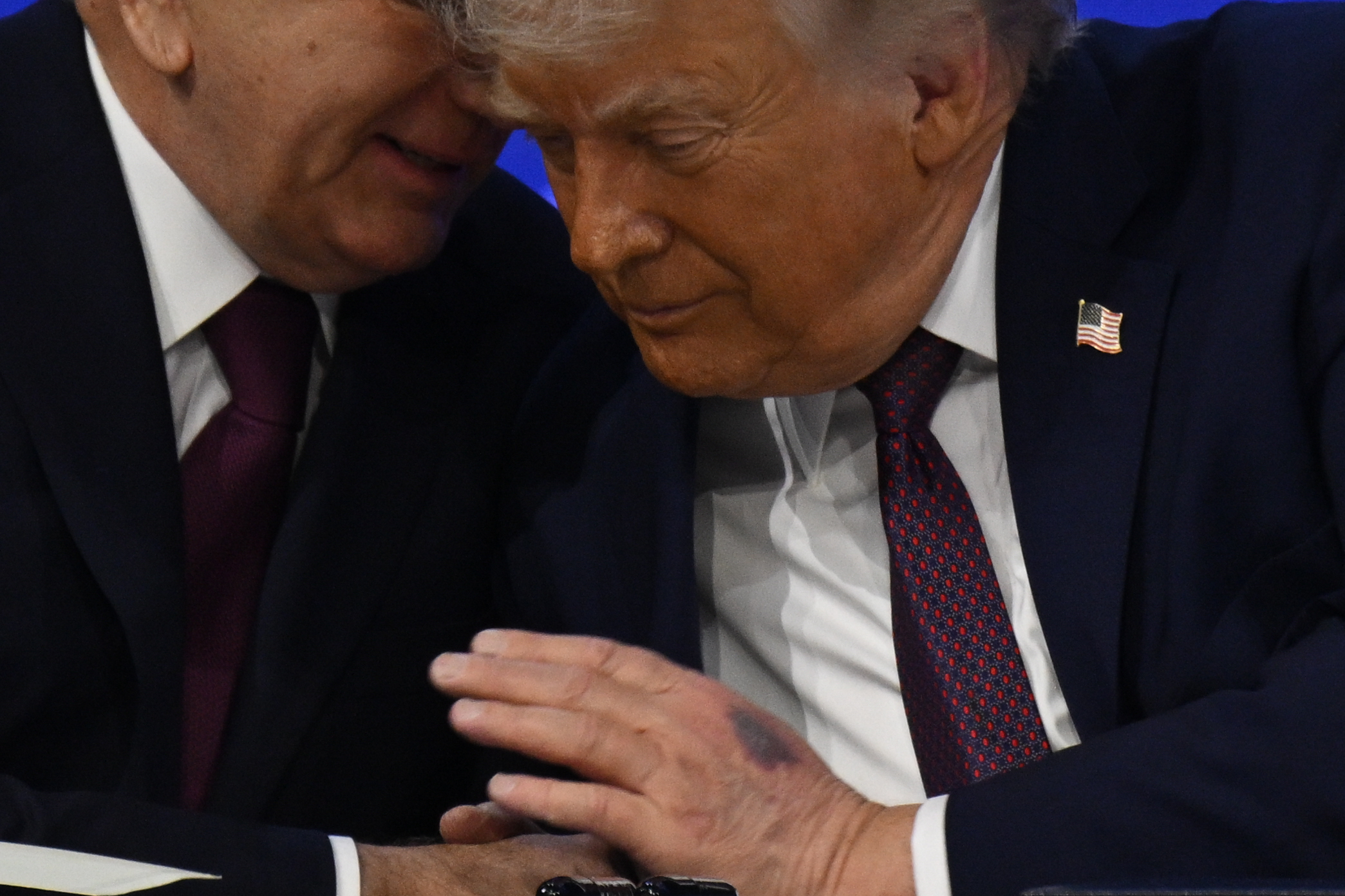 A close-up of Donald Trump listening to Shavkat Mirziyoyev, with Trump's bruised hand in full view. | Source: Getty Images