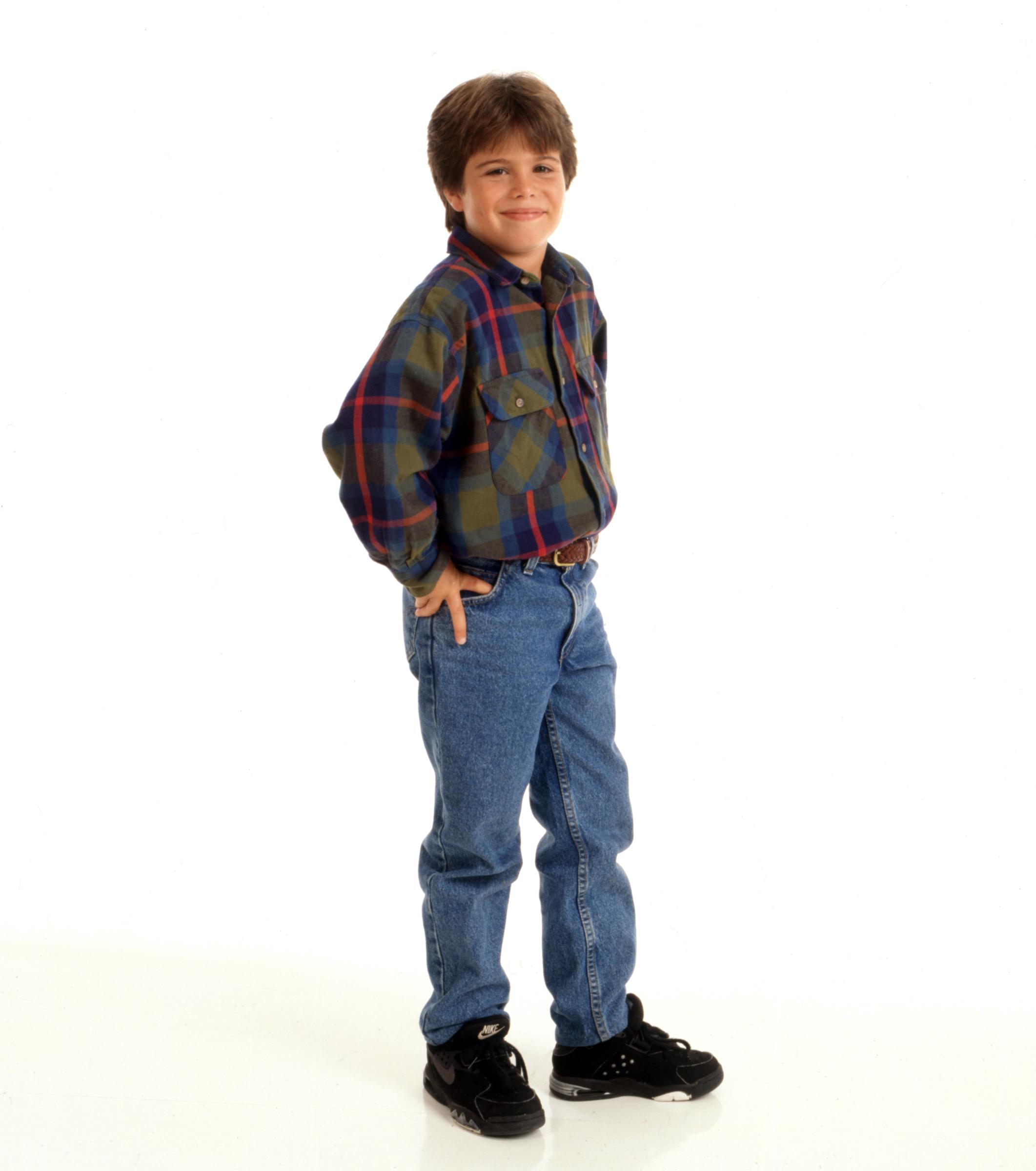 The young actor poses in a plaid shirt and jeans for a studio portrait, years before leaving Hollywood behind to pursue a career in the automotive industry. | Source: Getty Images.