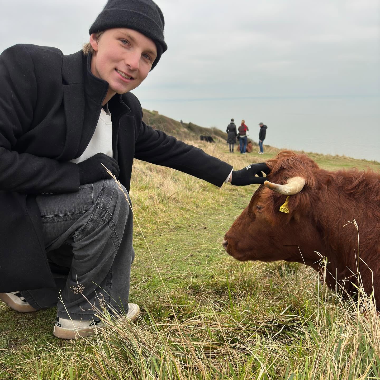 According to the parents, James Higginbotham would've been able to survive anything. In this photo, he is seen petting a cow in a picture uploaded on December 28, 2024 | Source: Facebook/Nancy Higginbotham