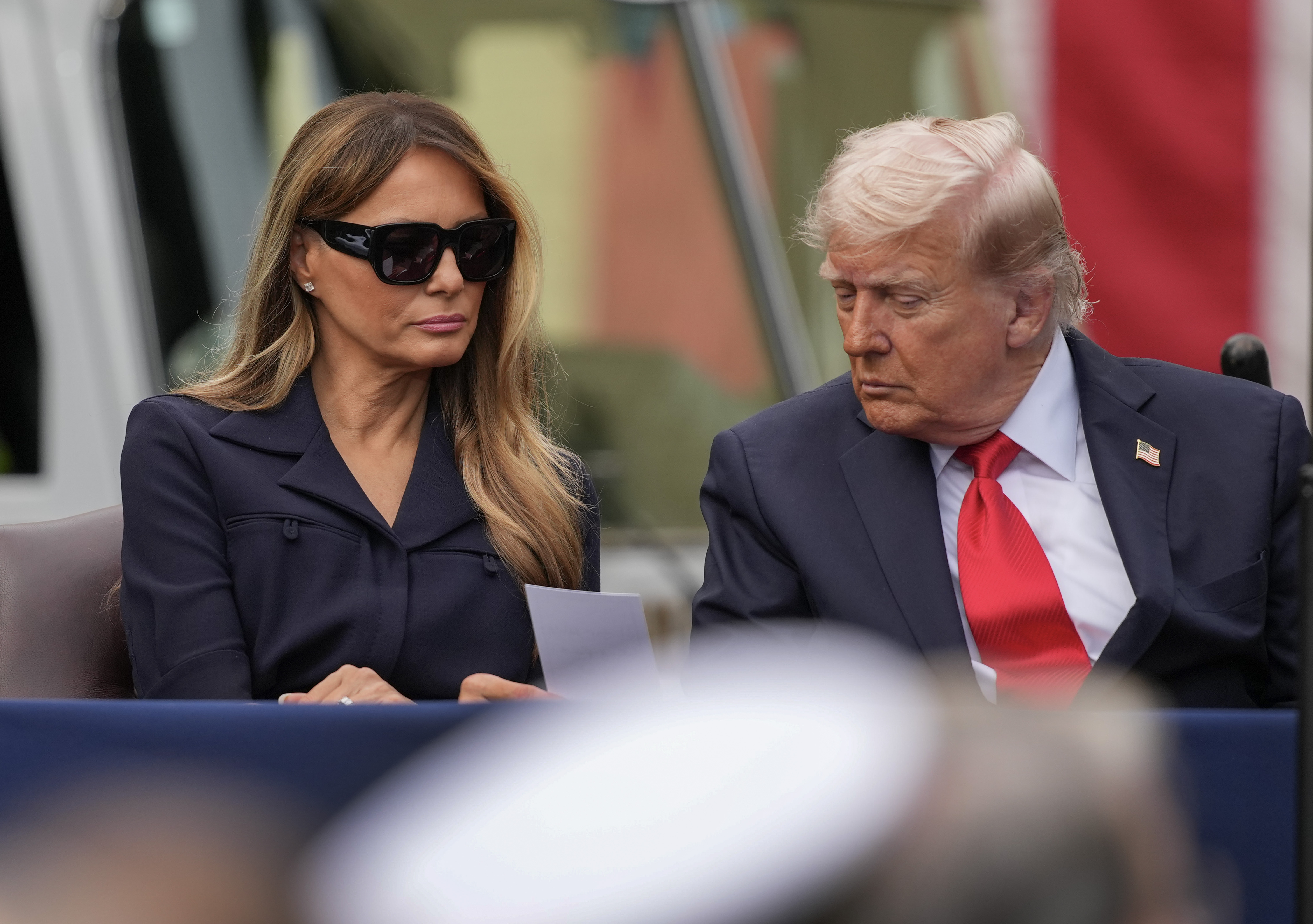 President Donald Trump and first lady Melania Trump read a note handed to them as they attend an observance event in the courtyard of the Pentagon on September 11, 2025 in Arlington, Virginia | Source: Getty Images