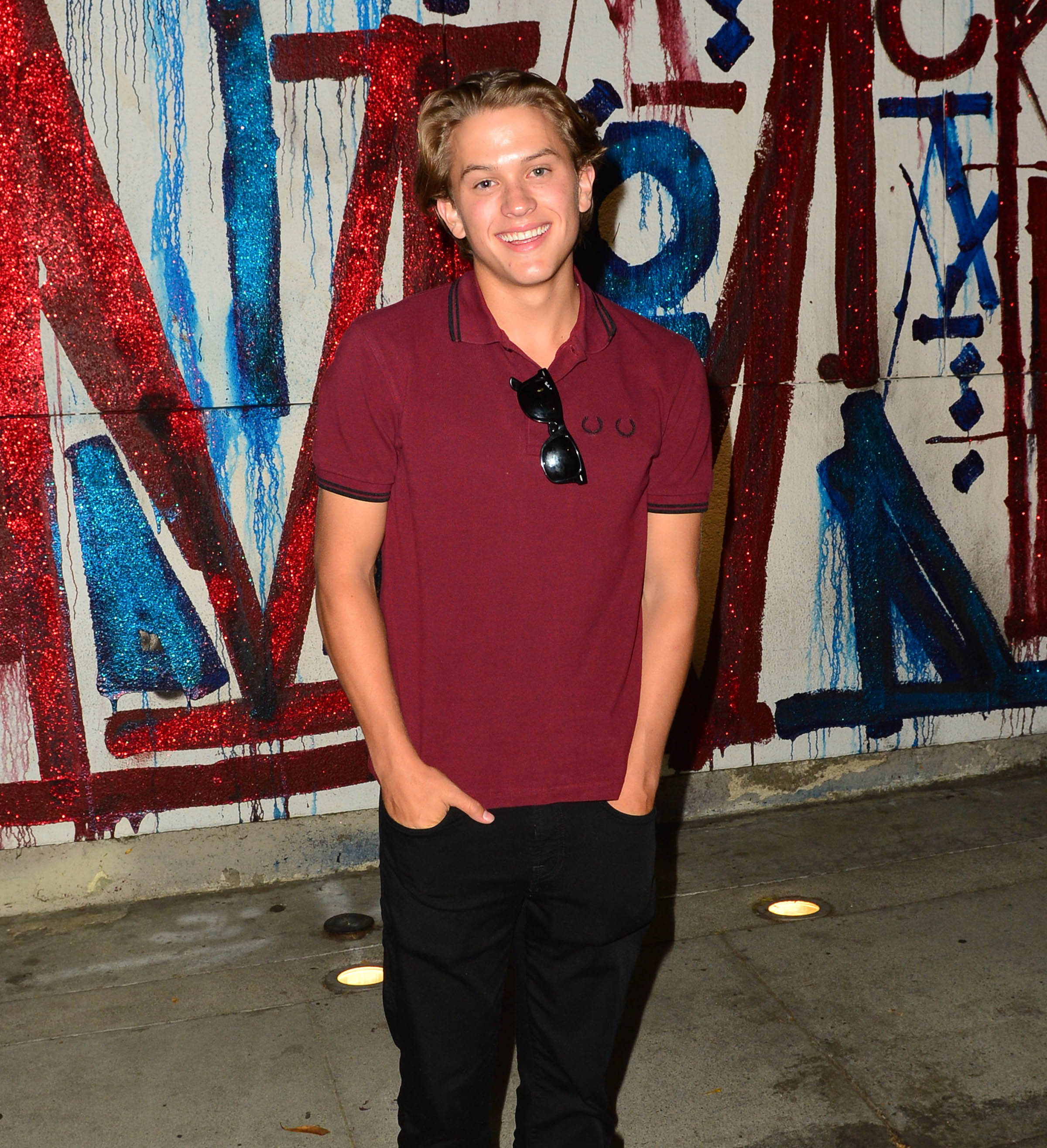 Fast-forward a few years, and Deacon was no longer the little boy tagging along at family events. Photographed solo in Los Angeles, he flashed a smile in a burgundy polo and black pants as he stepped into the spotlight on his own.