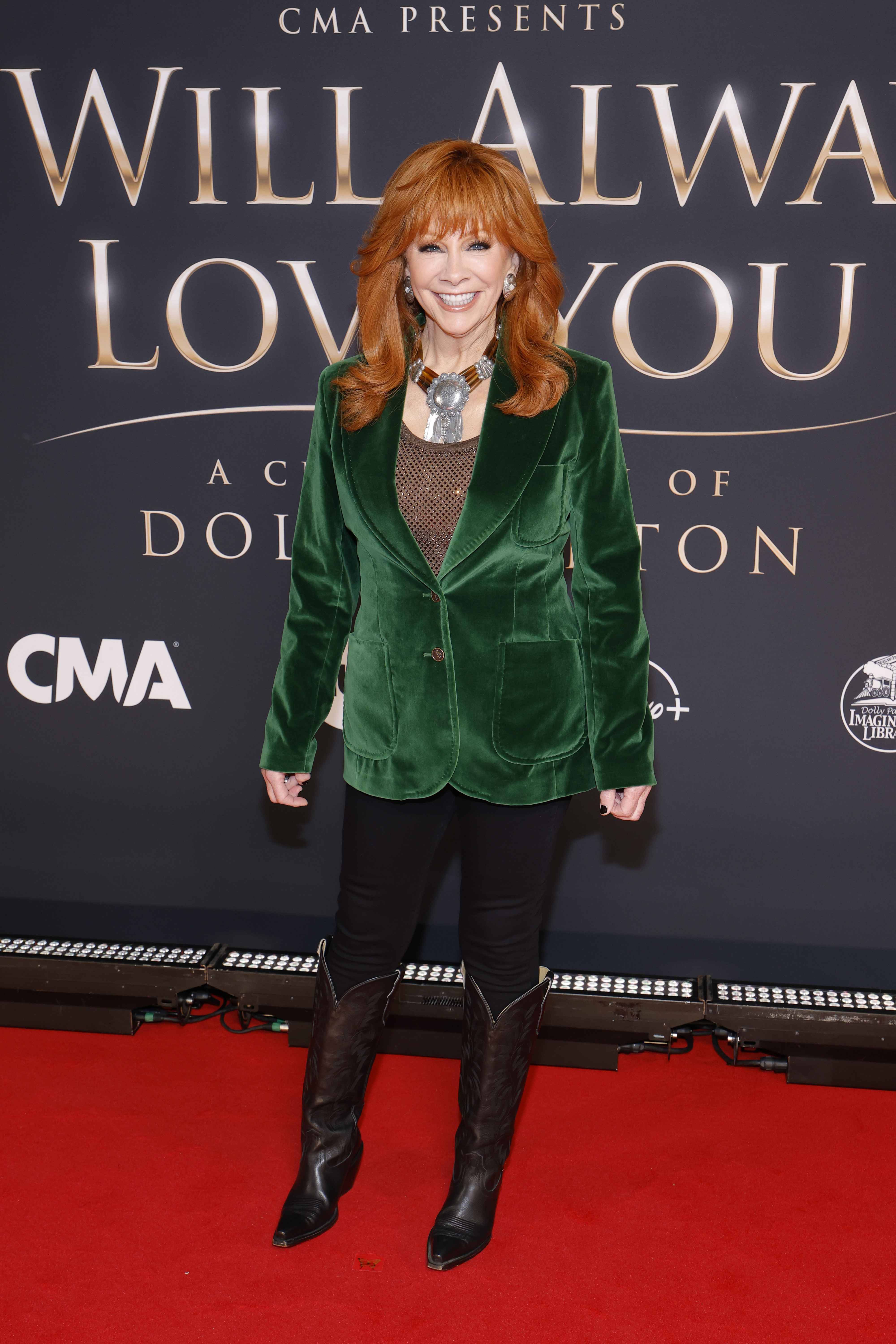 Reba McEntire steps onto the red carpet in an emerald velvet blazer at "CMA Presents I Will Always Love You: A Celebration of Dolly Parton" in Nashville on October 21, 2026. | Source: Getty Images