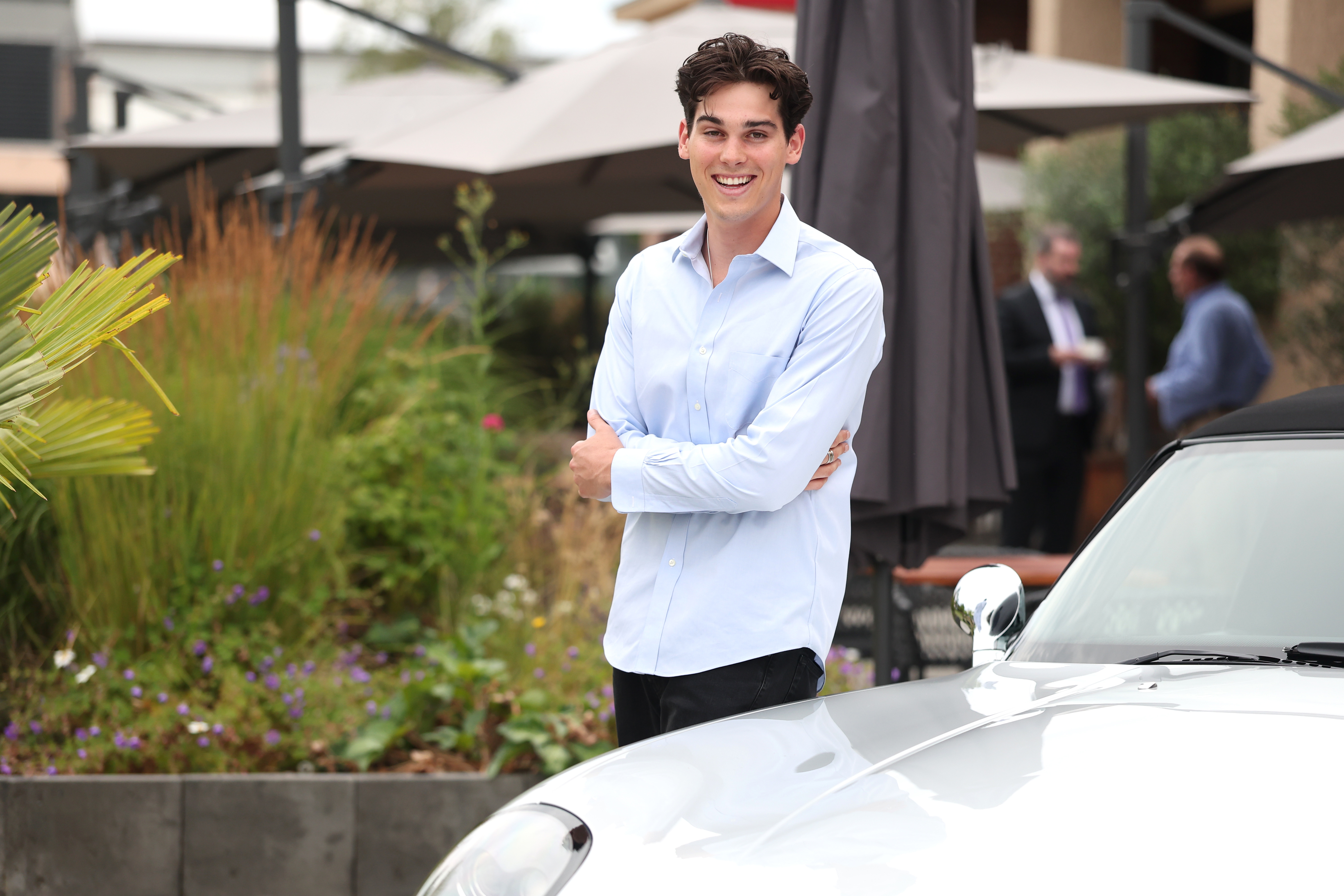 Paris Brosnan with the BMW Z8, which his father Pierce Brosnan drove during the James Bond 007 "The World Is Not Enough" film from 1999, on July 15, 2025 in Munich, Germany | Source: Getty Images
