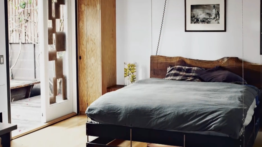 A suspended bed, designed to be raised out of the way when not in use, showcases one of the innovative space-saving features inside Vincent Kartheiser's 580-square-foot home. | Source: YouTube/Dwell