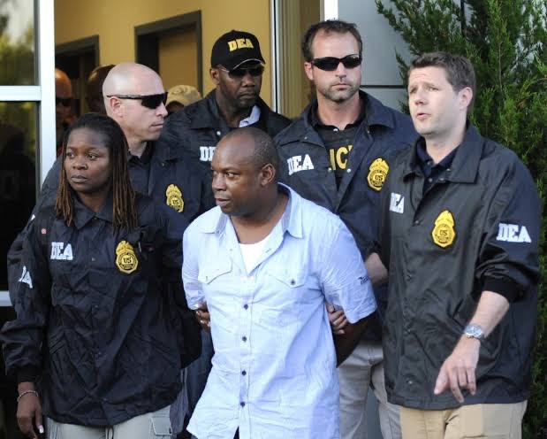 Following a deadly manhunt in Jamaica, the notorious drug lord was extradited to the United States under DEA escort in 2010. | Source: Getty Images