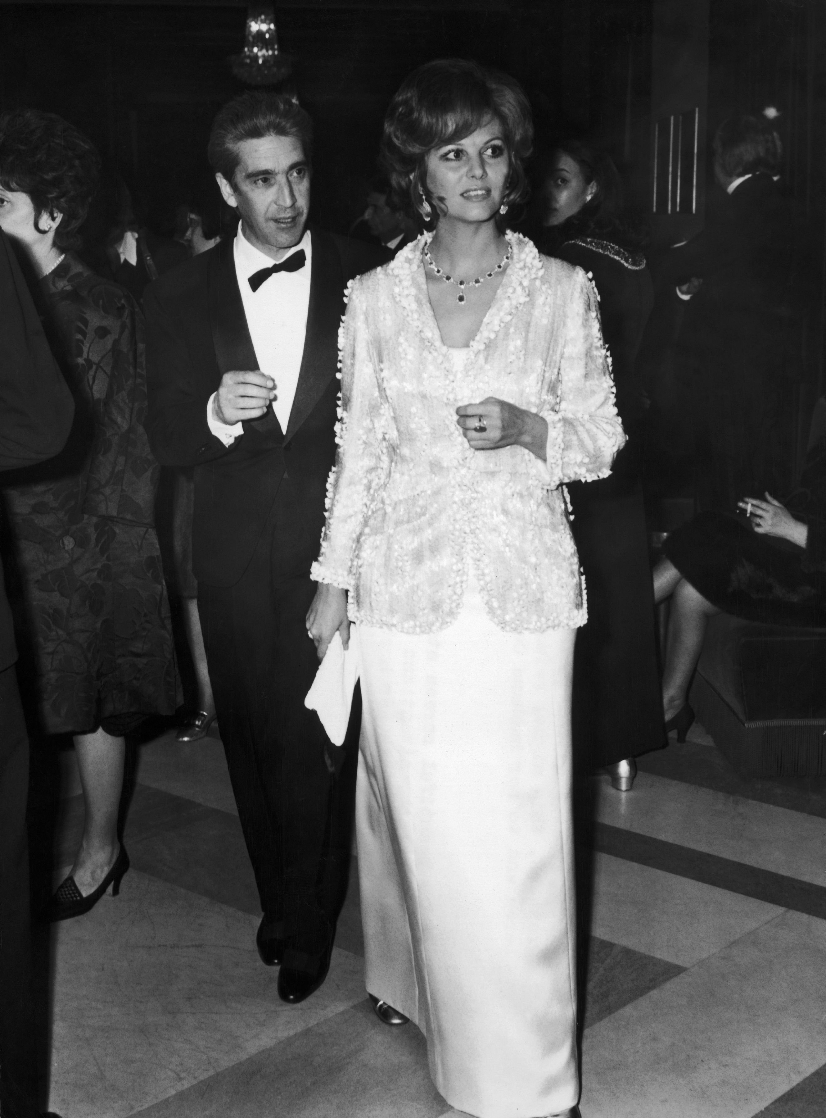 Franco Cristaldi and Claudia Cardinale arriving at The Rome Opera for the premiere of "The Film Les Fleurs Du Soleil" in Italy on March 14, 1970. | Source: Getty Images