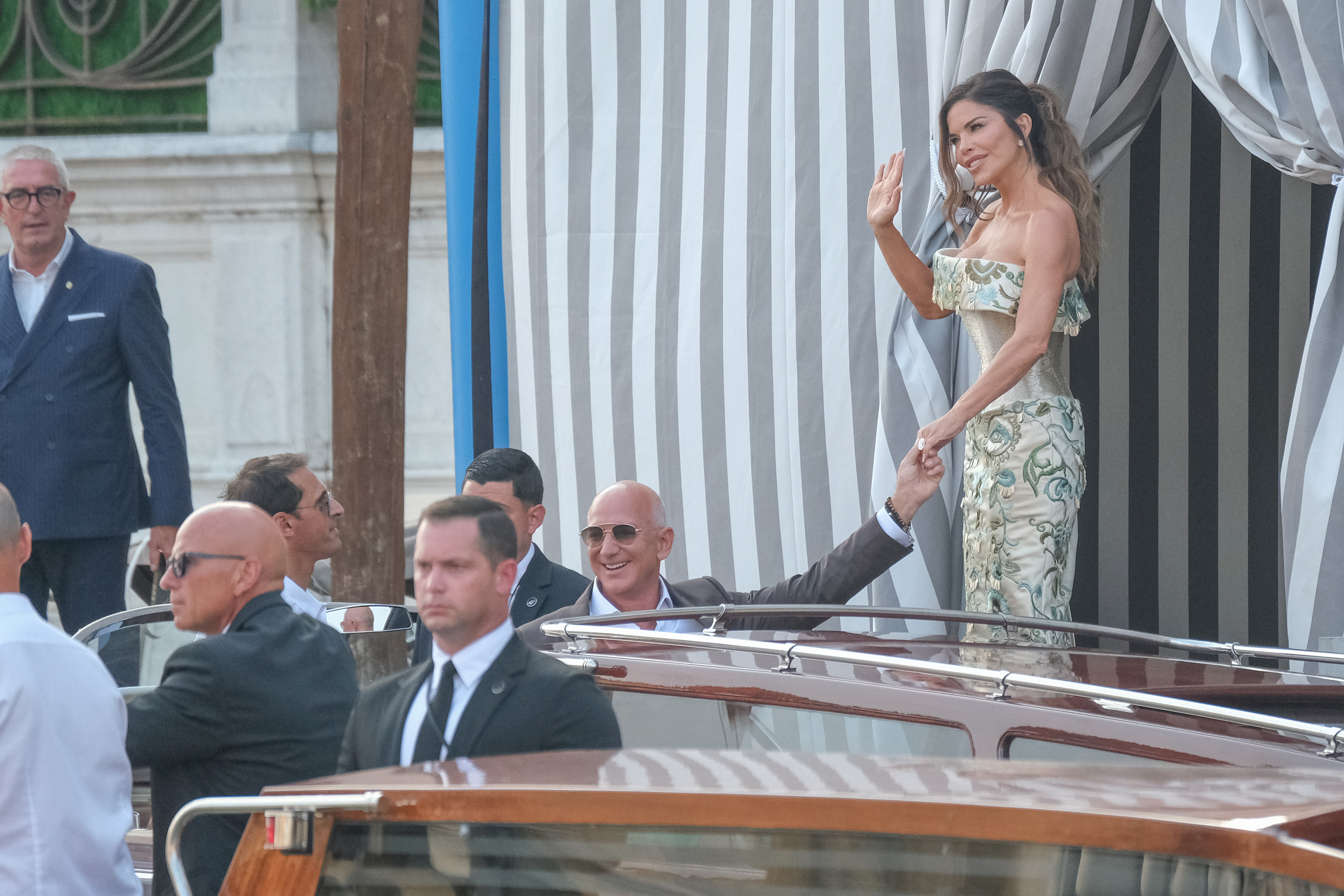 Lauren Sánchez waving while stepping onto a water taxi with Jeff Bezos ahead of their wedding dinner on June 26, 2025, in Venice, Italy | Source: Getty Images