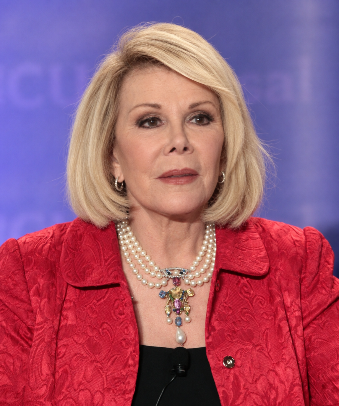 AI reimagines Joan with deeper forehead creases, crow's-feet, lines around her mouth, and more texture across her cheeks while maintaining her styled blonde hair. | Source: ChatGPT