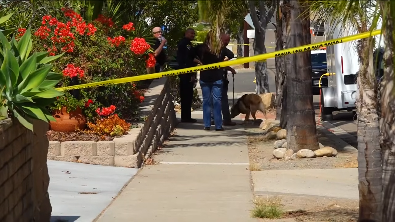 Officers work behind police tape near the Voight family's San Carlos home following the discovery of Amy, David, and Mya Voight. | Source: YouTube/FOX 5 San Diego