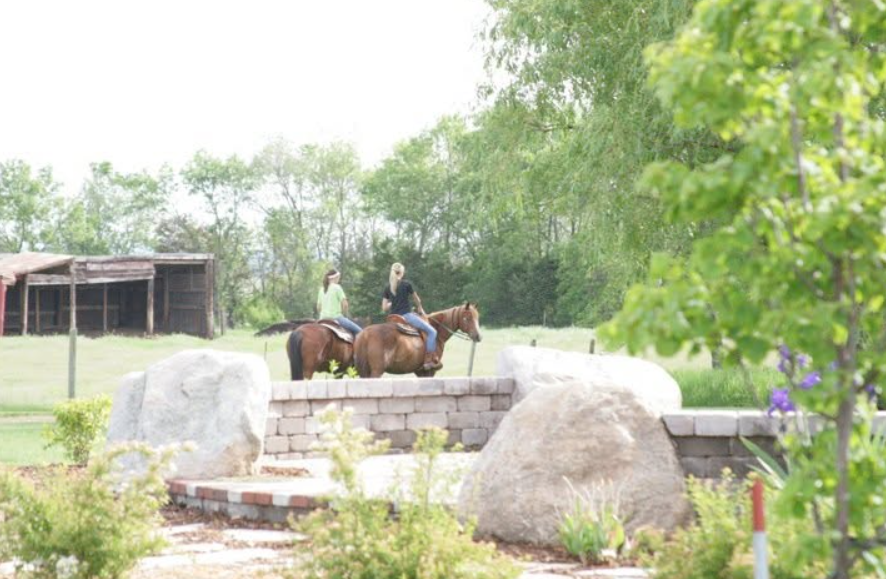 The area around the Noems' home includes landscaped sections as well as space for horses. This view shows how the maintained yard meets the wider rural setting. | Source: Facebook/kristi.noem