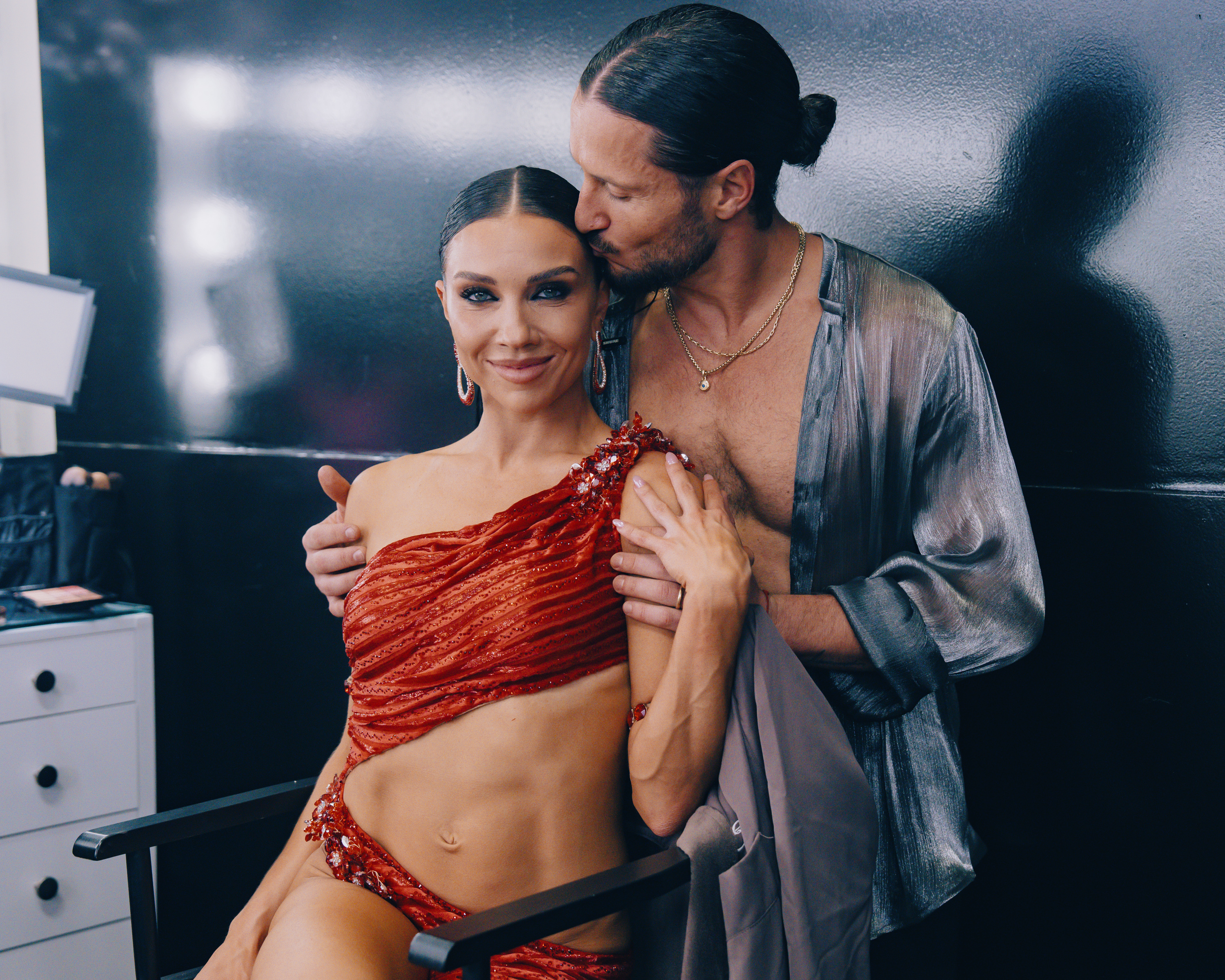 Val Chmerkovskiy places a gentle kiss on his wife Jenna Johnson backstage during "Mariah Carey Night" on "Dancing with the Stars" on October 6, 2026. Both seasoned ballroom champions competing in season 35, the couple has long been one of the show's favorite pairs. Val's deep protective instincts toward his wife would soon spark controversy after a judging dispute involving her routine escalated online, ultimately costing him his place on the dance floor for the following week's performance. | Source: Getty Images