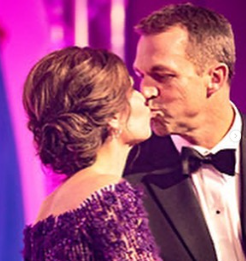 Mid-kiss under soft, colorful lighting, Kristi and Bryon share a playful, affectionate moment—brief, candid, and full of warmth. | Source: Instagram/sdbryonnoem