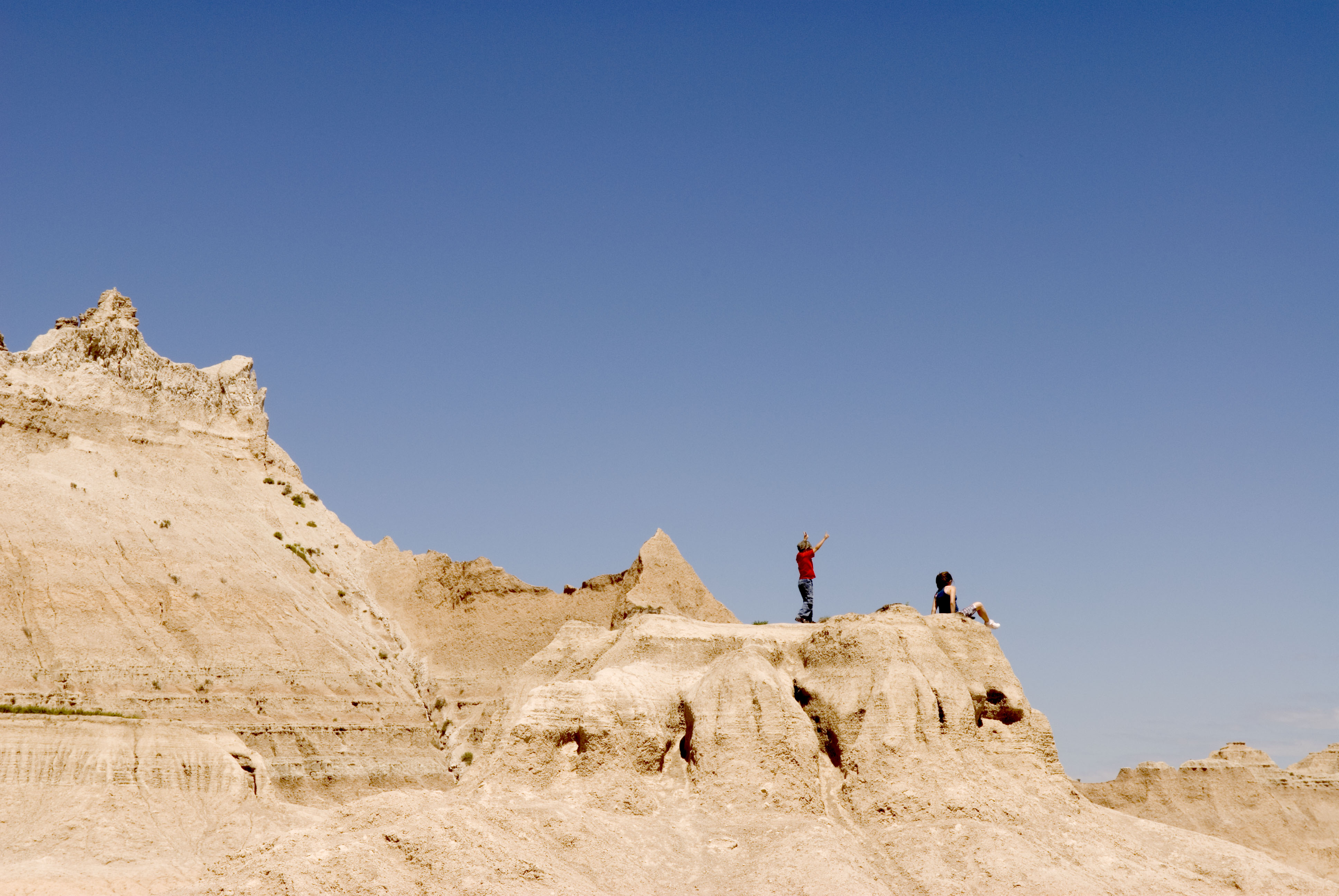 Children stand atop a sun-scorched hill in Badlands National Park, South Dakota, on August 28, 2005 | Source: Getty Images