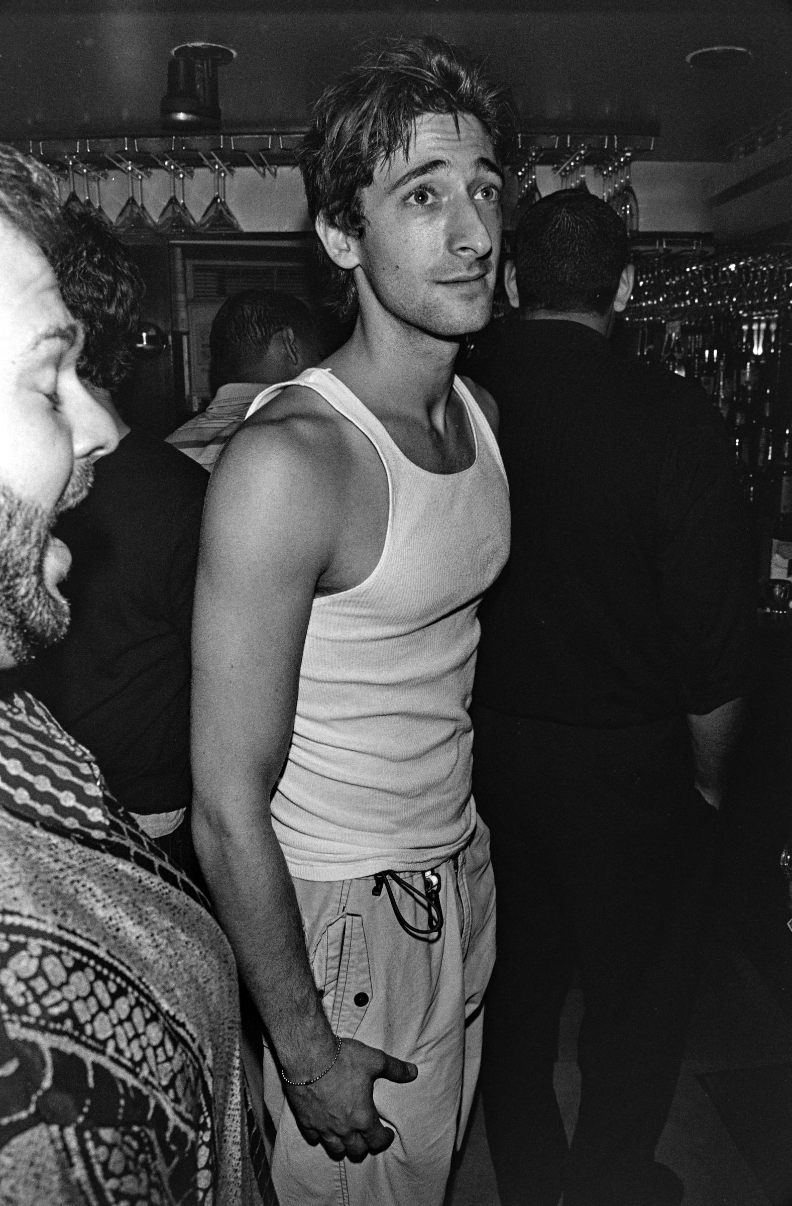 Adrien Brody appeared relaxed in a fitted white tank top while attending a party at Halo in New York City on July 24, 1999, several years before the dramatic physical transformation he would undergo for "The Pianist." With filming still well ahead of him, the actor appeared notably fuller than he would at 129 pounds while preparing to portray Władysław Szpilman.