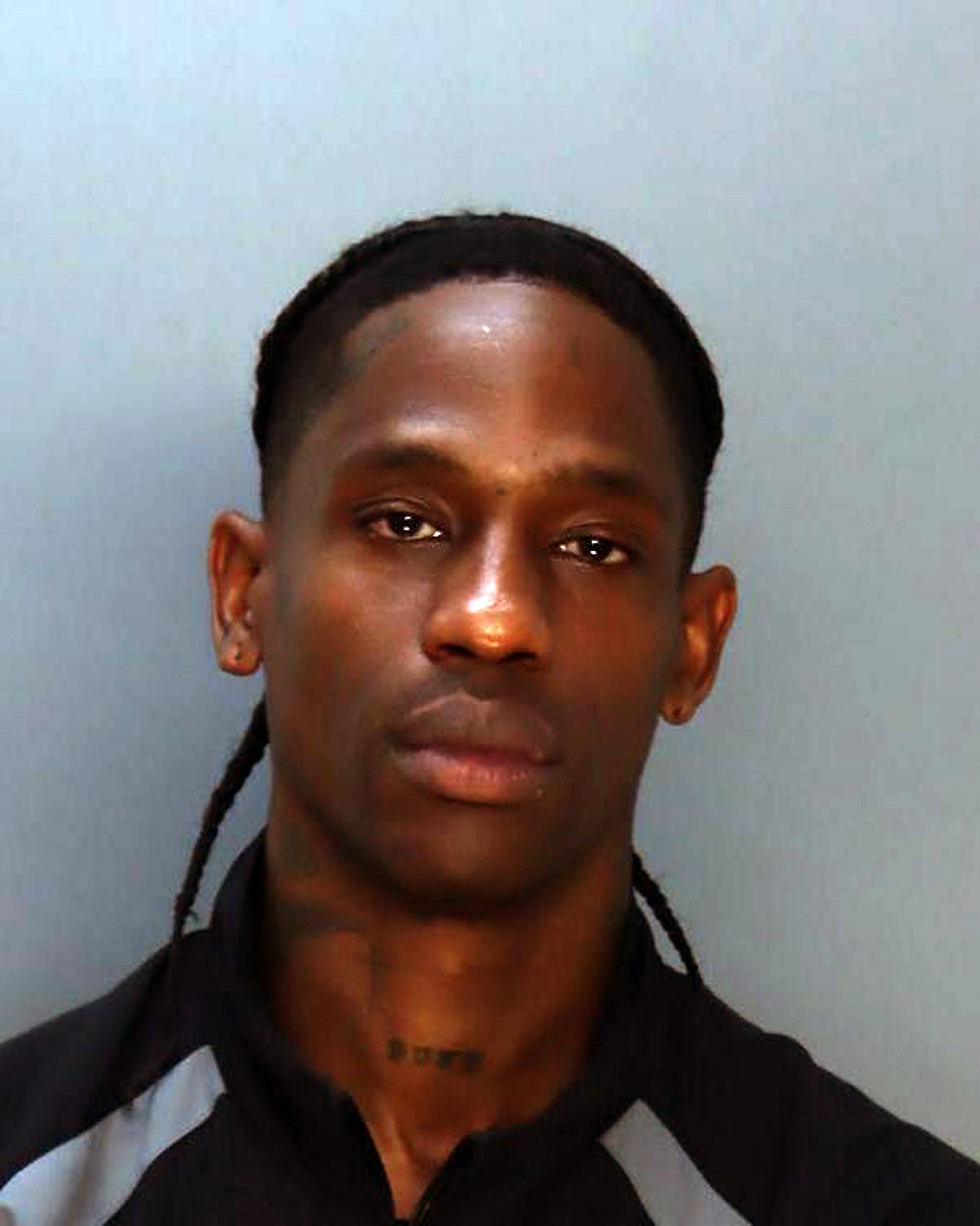 Travis Scott posing for his mugshot in Miami, Florida on June 20, 2024. | Source: Getty Images