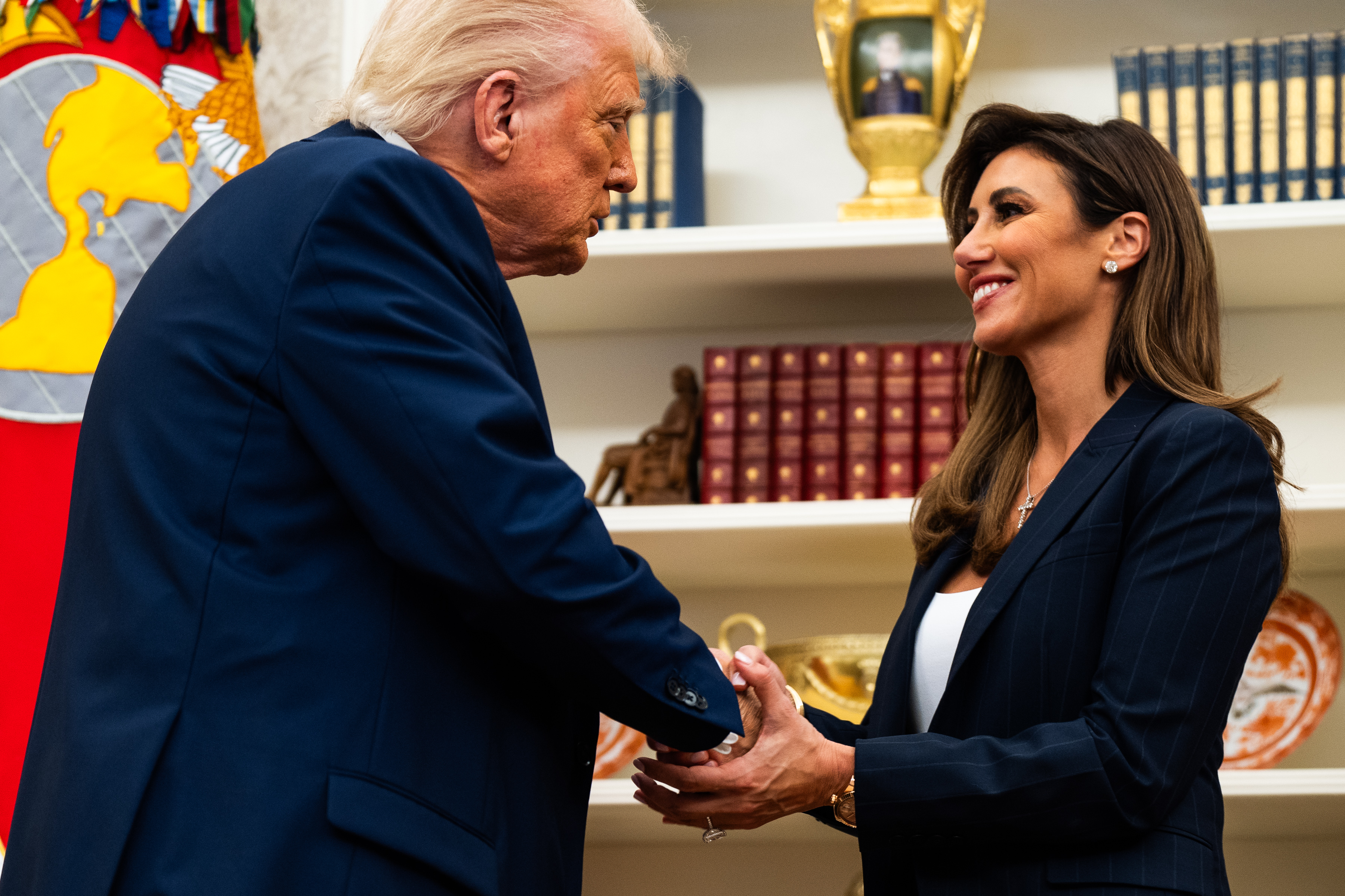 President Donald Trump shakes hands with Alina Habba, the then-U.S. attorney for New Jersey, in the Oval Office at the White House on March 28, 2025. According to the New York Post, Habba is among the early names being discussed as a possible replacement for Karoline Leavitt. She previously served as one of Trump's defense lawyers and briefly worked in the West Wing as a counselor to the president. | Source: Getty Images