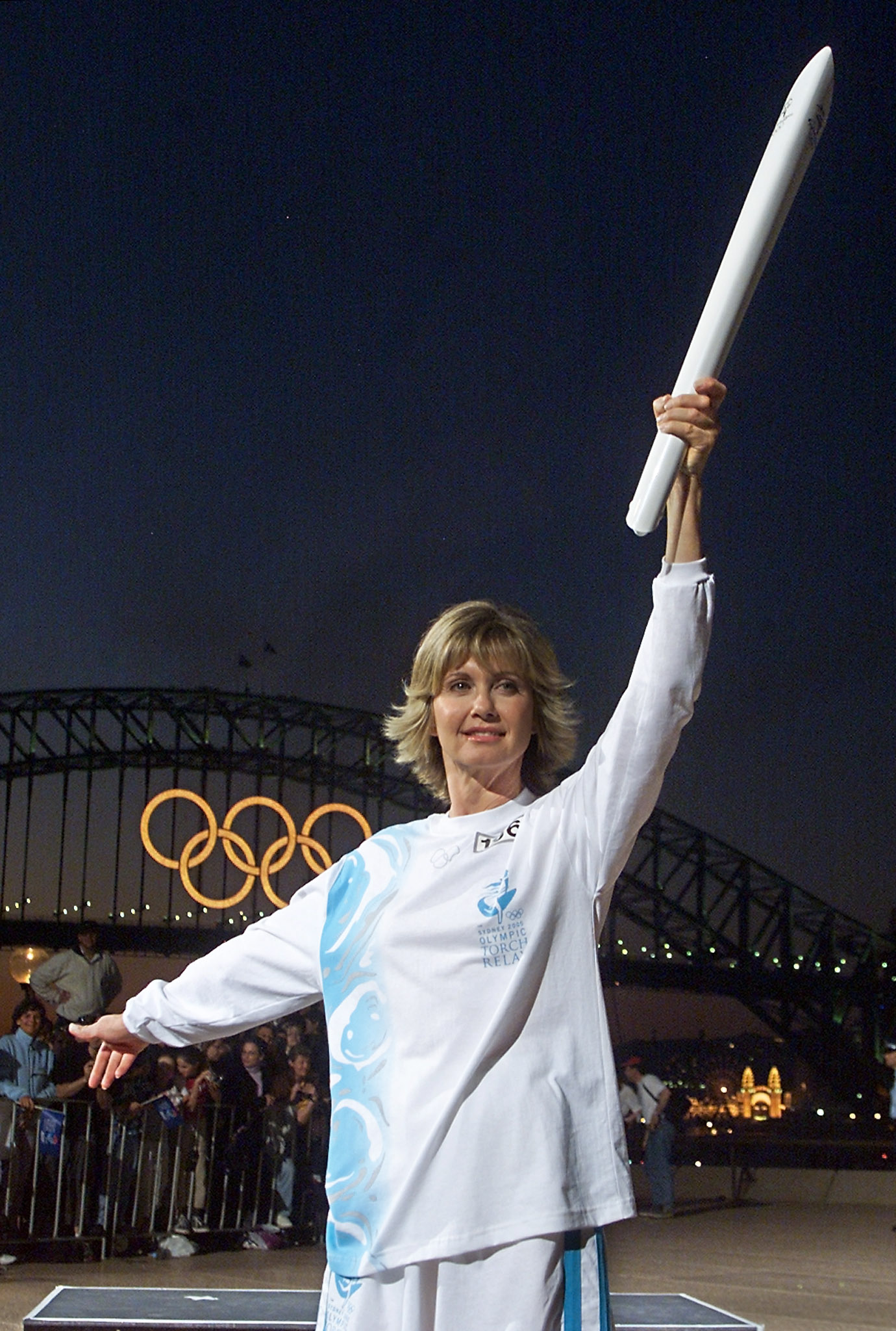 Olivia Newton-John at 51 years old. [Photo taken on September 14, 2000]. | Fun Fact: The Sydney Olympics gave Olivia one of the most memorable honors of her career: she carried the Olympic torch during its relay and then joined John Farnham at the Opening Ceremony to perform "Dare to Dream." Olivia's official biography later described the torch relay as one of her most treasured memories.