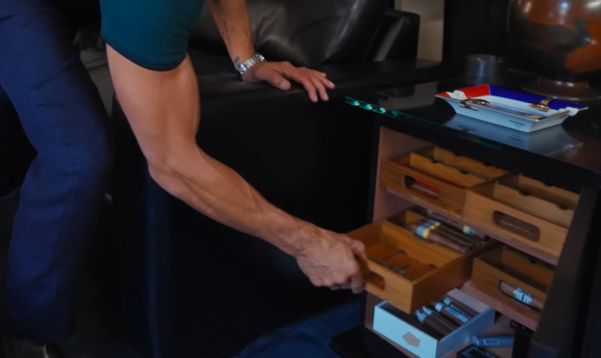 Mark's cigar drawers make the room's purpose unmistakable. Still, the couple's jokes about smoking rules keep the space from feeling overly serious. | Source: YouTube/Architectural Digest