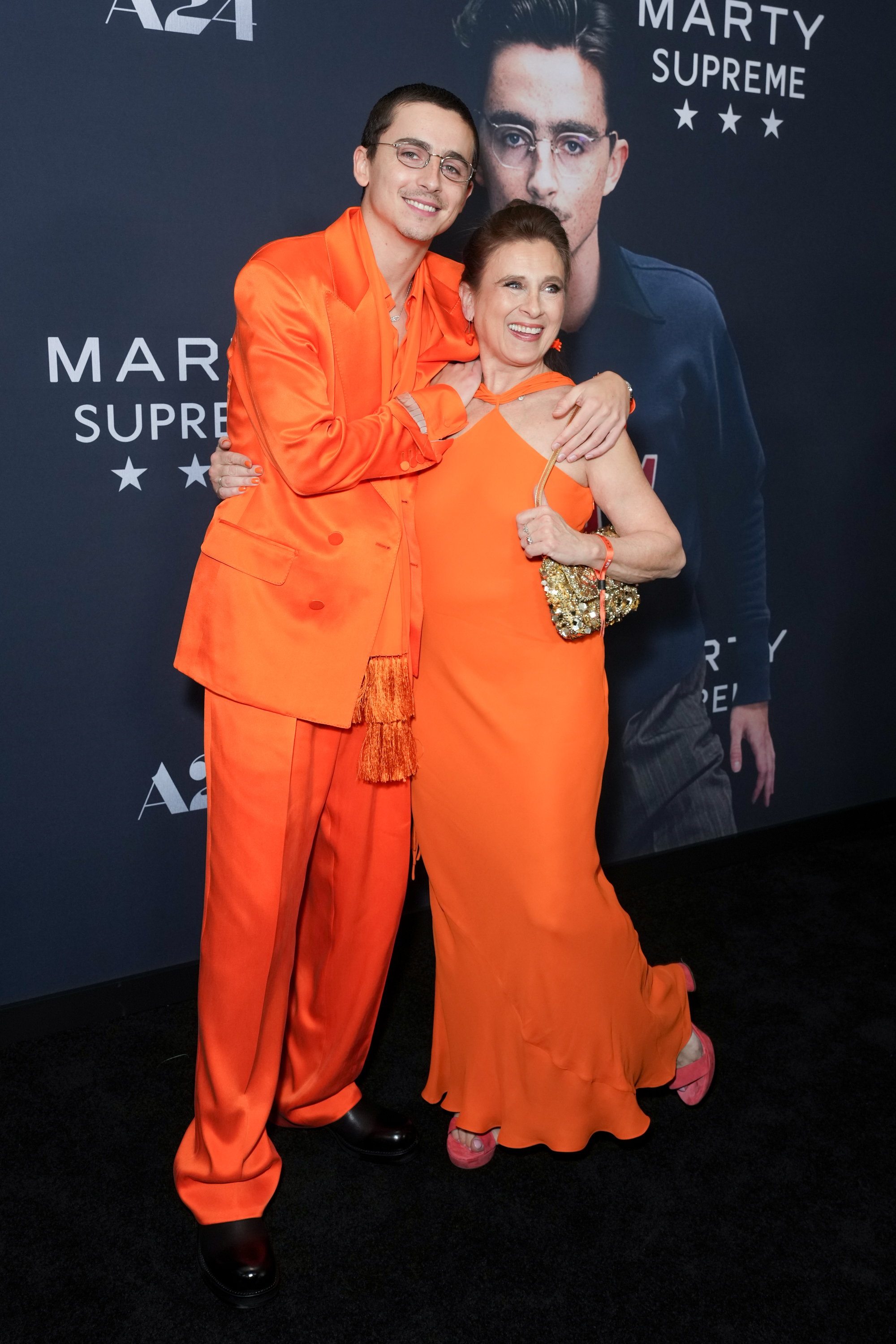 Timothée Chalamet and Nicole Flender-Chalamet posing on the carpet. | Source: Getty Images