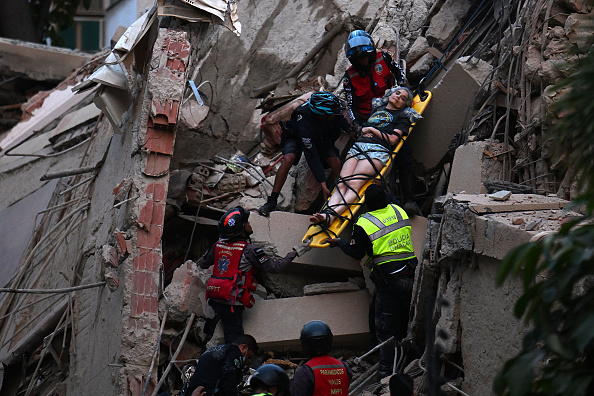 Emergency responders evacuate an injured person on a stretcher from the debris of a collapsed building after an earthquake struck Caracas, Venezuela, on June 24, 2026. | Source: Getty Images