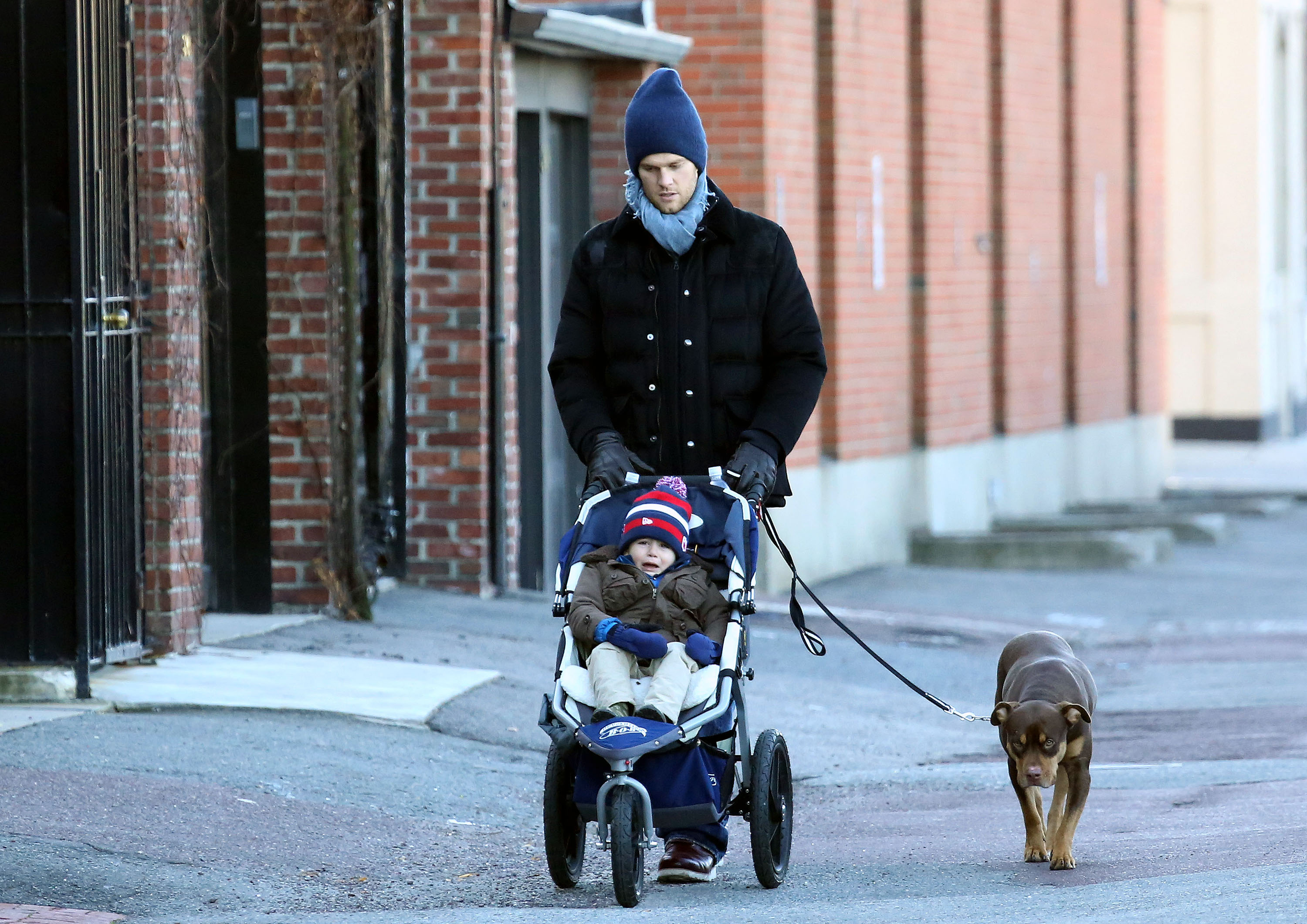 One of the earliest public photos of Benjamin Brady shows him as a toddler in December 2012, sitting in a stroller during a walk with his father and the family's dog in Boston. At the time, he was a small child bundled up against the winter weather.