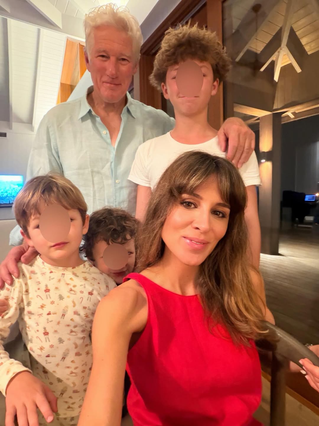 Richard Gere and Alejandra Silva pose with their children inside the family's Spain home, where exposed beams, wood accents, and warm lighting create a cozy setting for family gatherings. | Source: Instagram/alejandragere