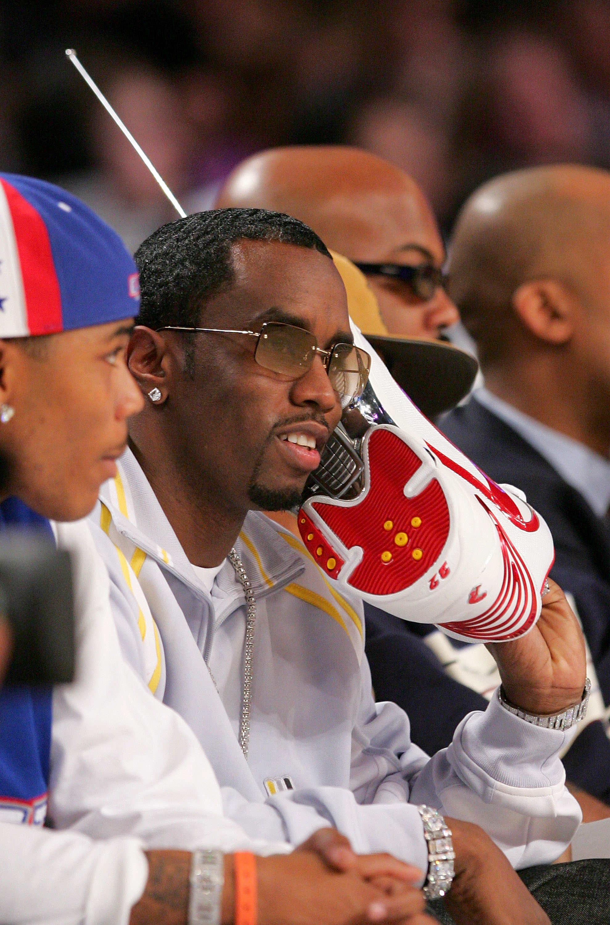 Combs had always been known for his extravagant style and love of attention, even playfully holding a sneaker to his ear like a phone during a basketball game. | Source: Getty Images